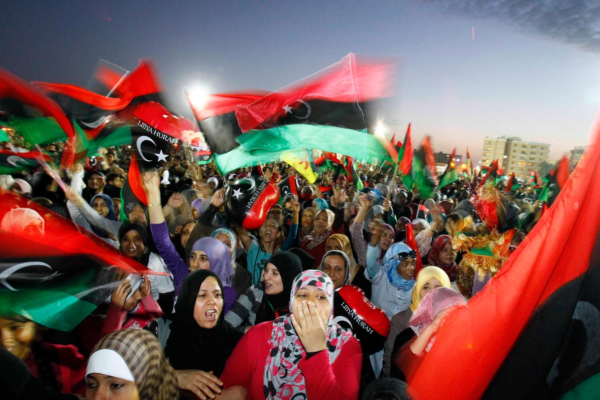 In this Sunday Oct. 23, 2011 file photo, Libyan celebrate at Saha Kish Square in Benghazi, Libya, as Libya's transitional government declares the official liberation of Libya after months of bloodshed that culminated in the death of longtime leader Moamma