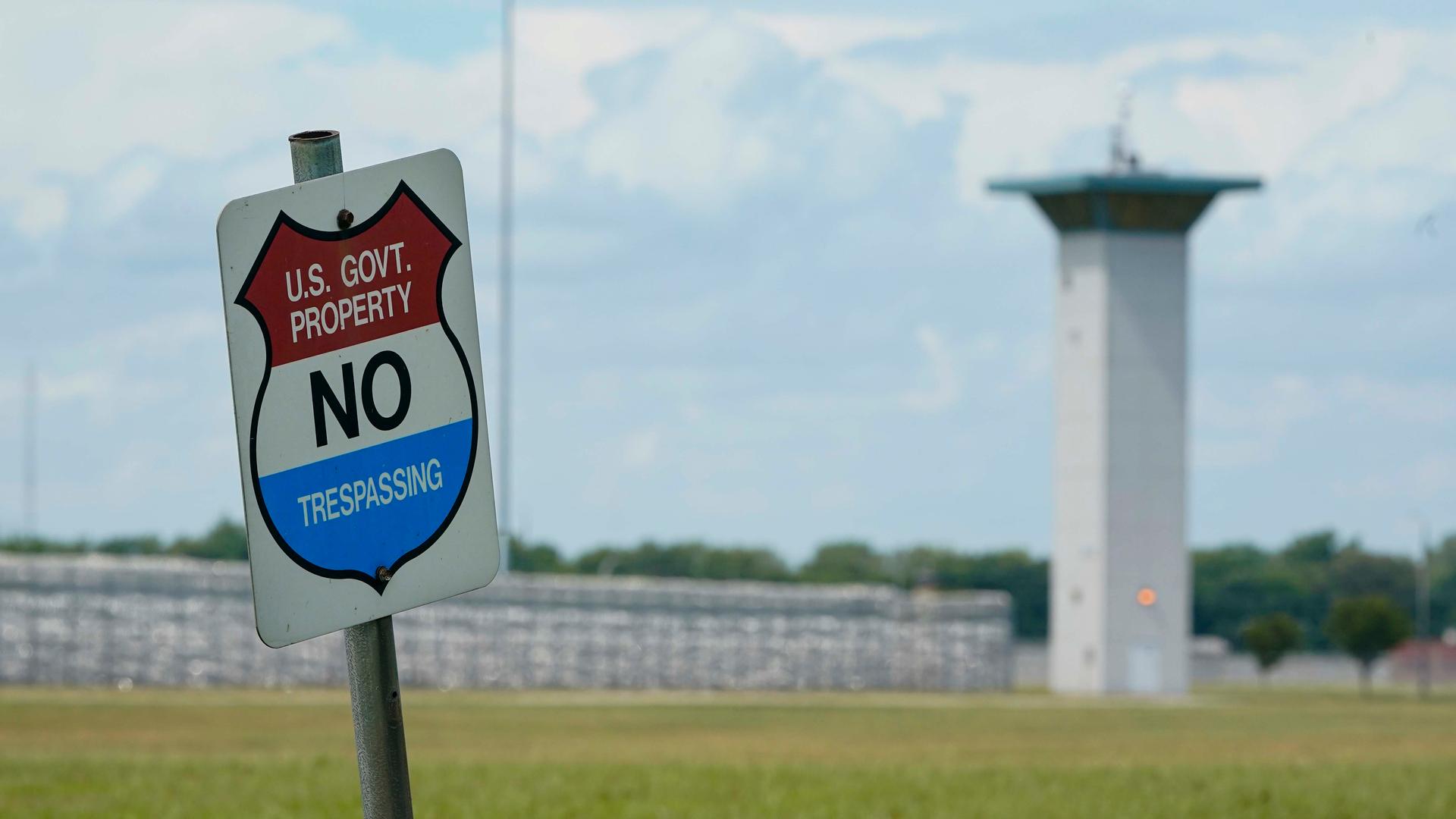 In this Aug. 28, 2020, file photo, a no-trespassing sign is displayed outside the federal prison complex in Terre Haute, Ind. As Donald Trump’s presidency winds down, his administration is throttling up the pace of federal executions despite a surge of CO