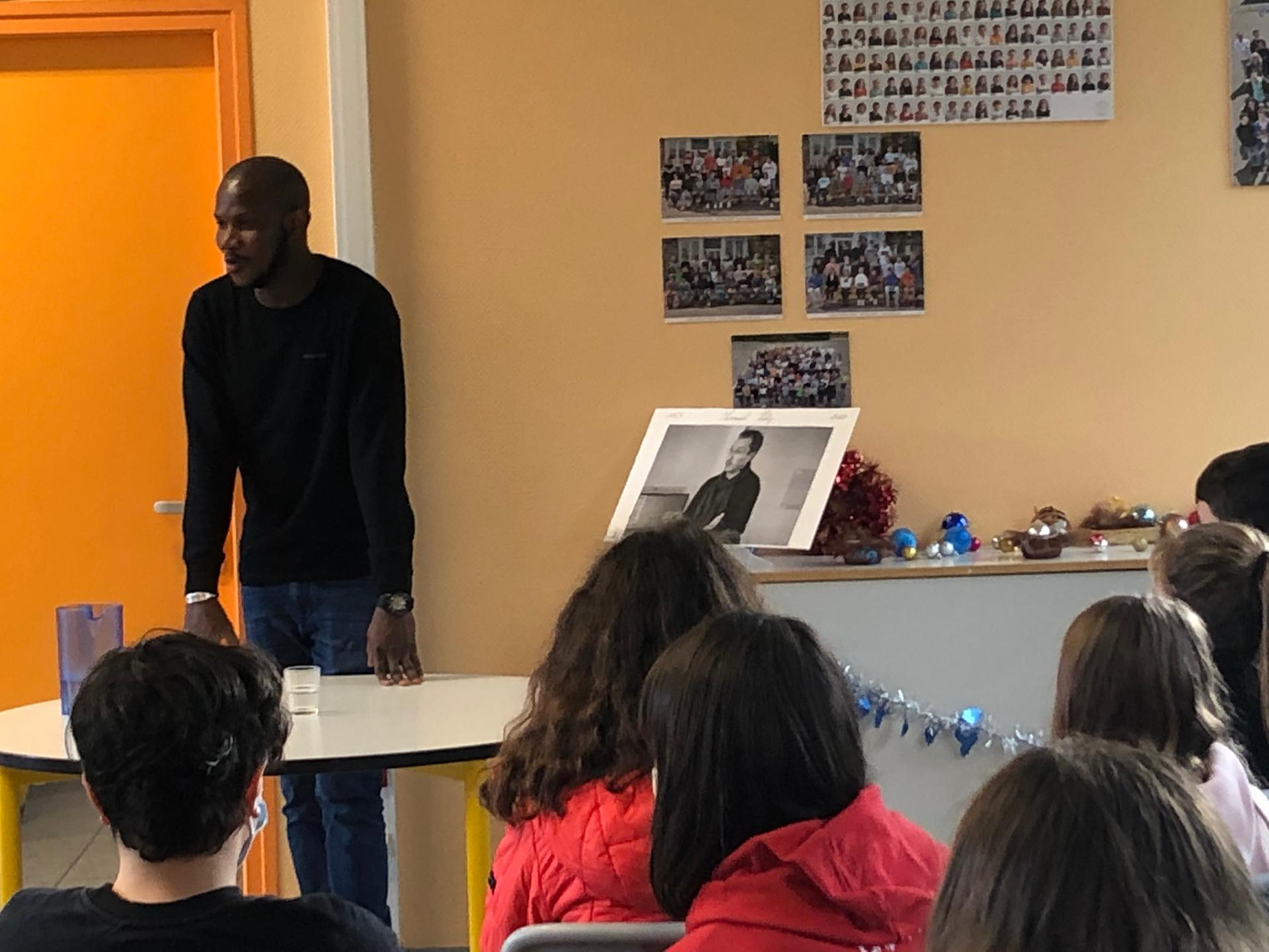 Lassana Bathily speaks to a group of students at Francois Charles Middle School in Plougasnou, France, Dec. 11, 2020.