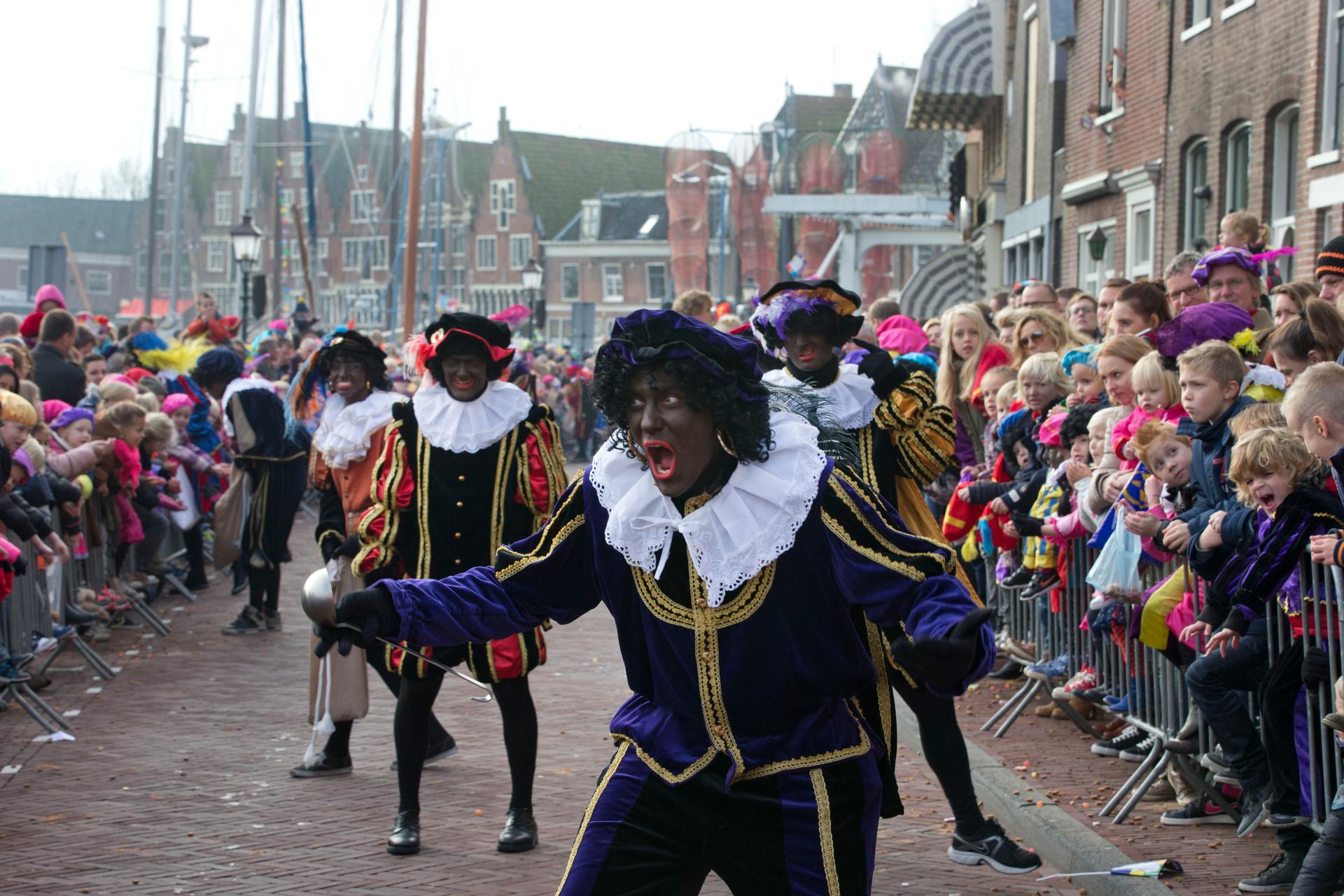 Dutch white people in blackface and colorful costumes