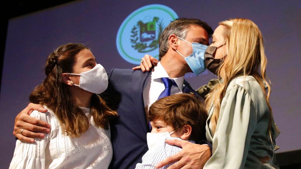 Venezuelan opposition leader Leopoldo López kisses his wife Lilian Tintori with their son and daughter after a news conference in Madrid on Oct. 27, 2020. López who has abandoned the Spanish ambassador's residence in Caracas and left Venezuela after years