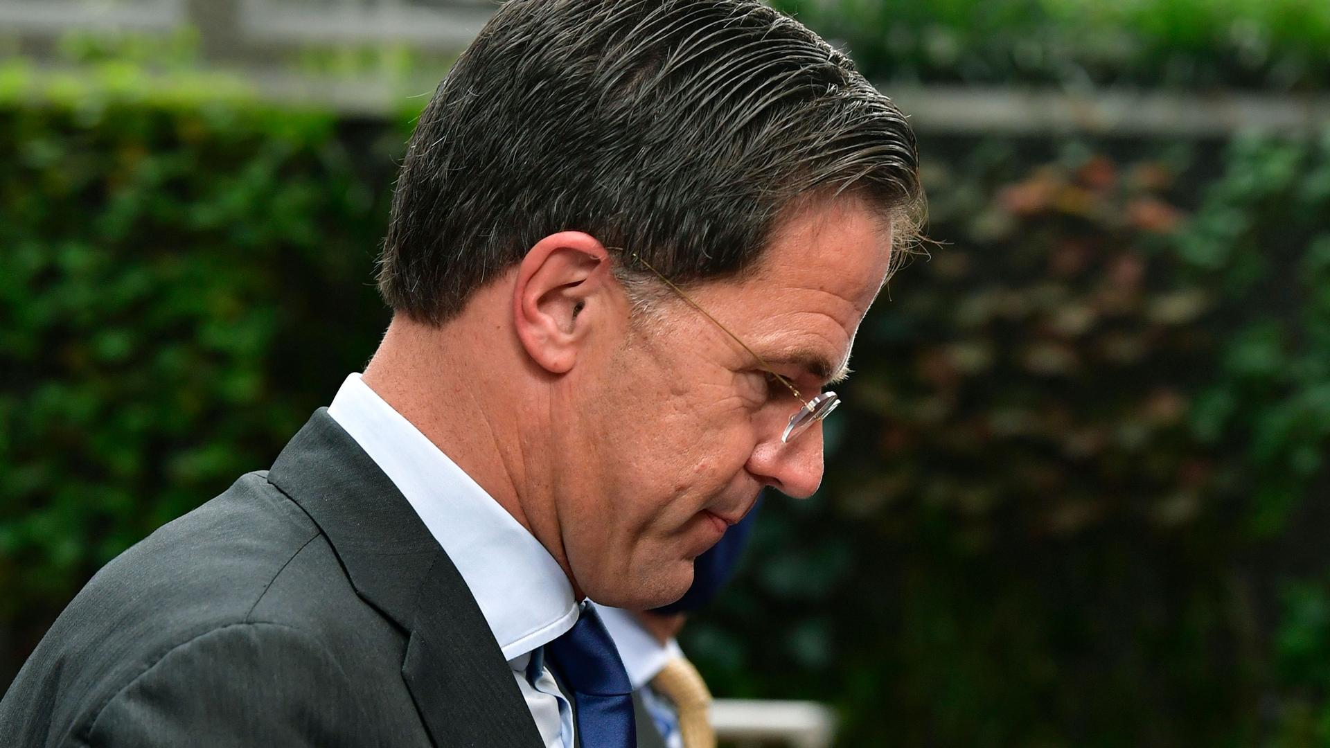 Netherlands' Prime Minister Mark Rutte is shown in a close-up photograph wearing a gray suit and looking down.