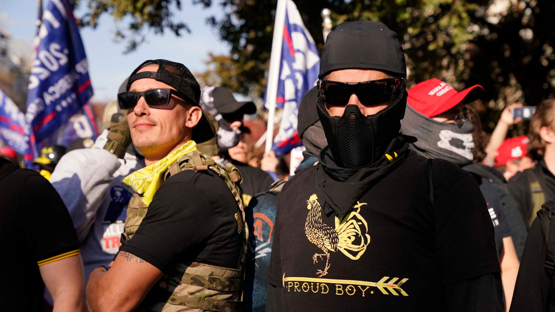 People wearing shirts with Proud Boys on them join supporters of President Donald Trump in a march Nov. 14, 2020, in Washington, DC.