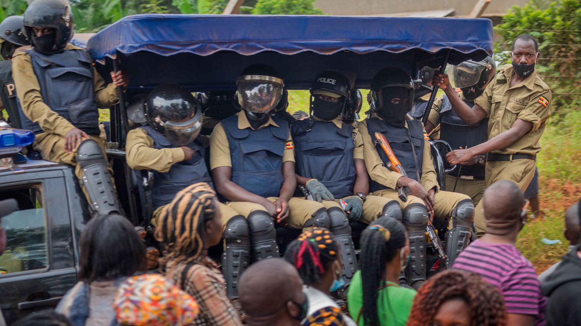 Security forces drive past a polling station in Kampala, Uganda, Jan. 14, 2021.