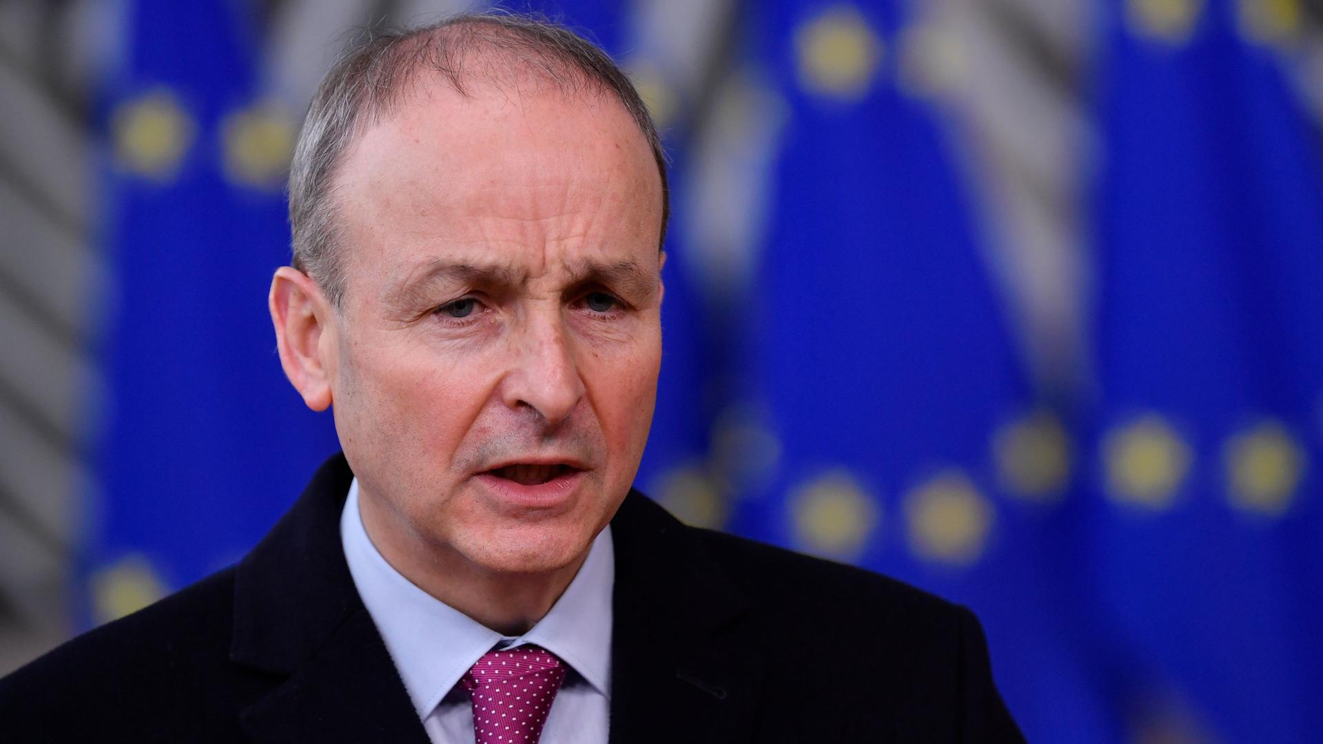 Ireland's Prime Minister Micheal Martin is shown wearing a dark suit jacket and red tie.