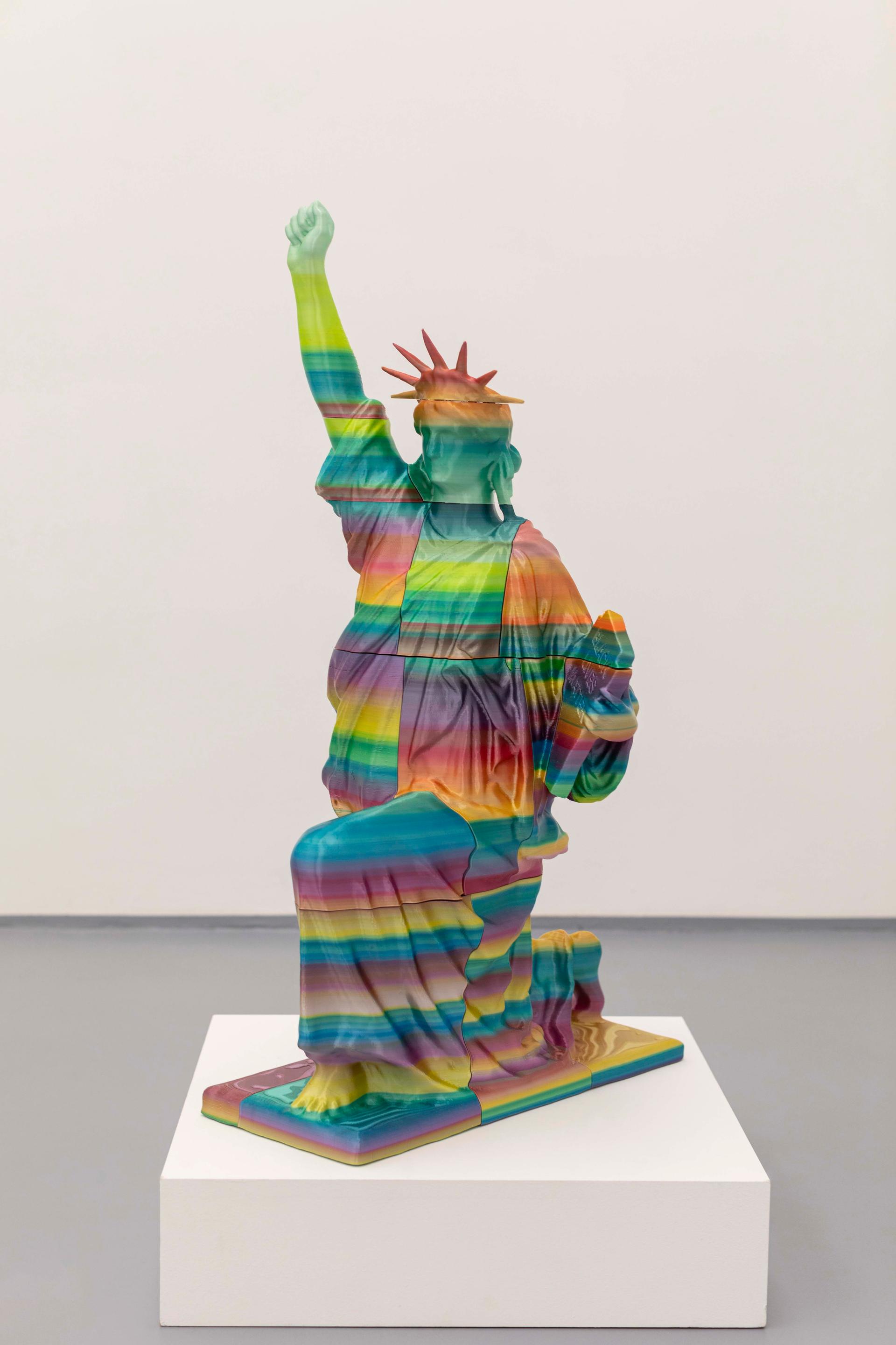 A miniature sculpture of Lady Liberty holding a tablet that reads 