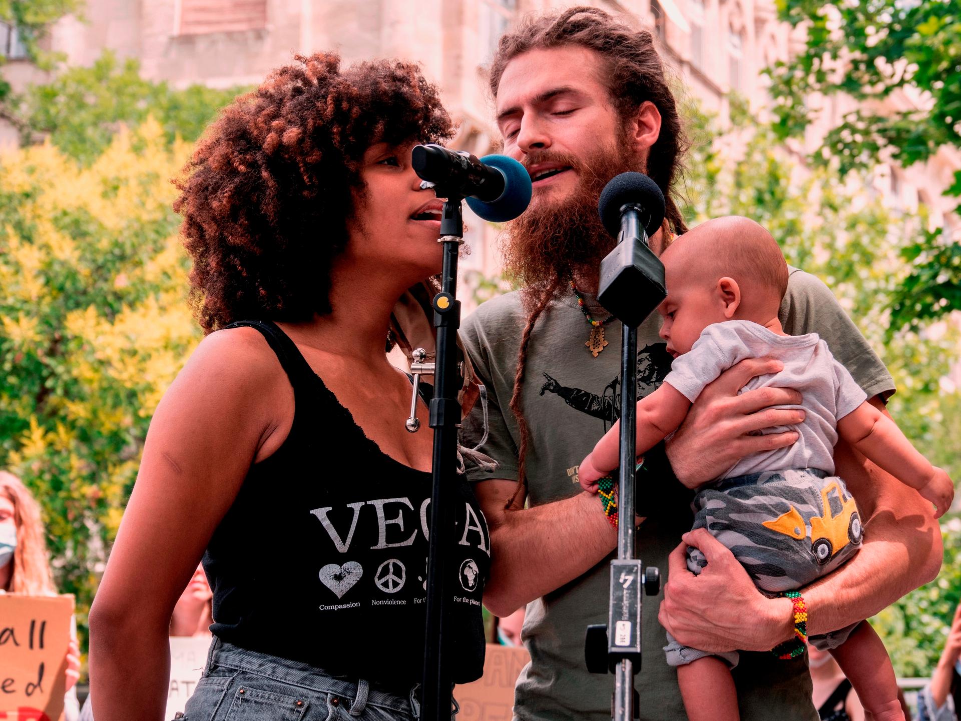 Gregory G Ras, a reggae singer and activist, organized the main Black Lives Matter march in Budapest last summer. His wife and baby Noah are pictured with him. 
