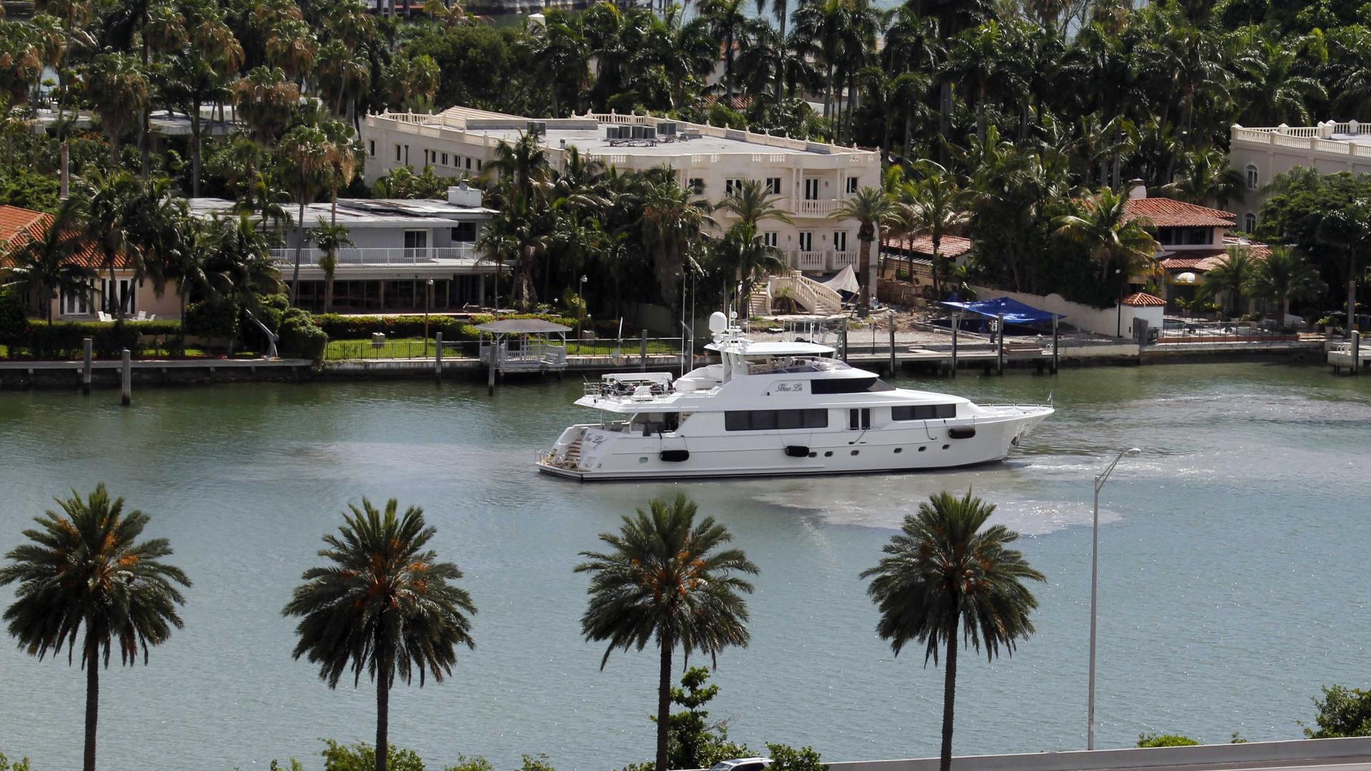 A yacht maneuvers near homes on Palm Island