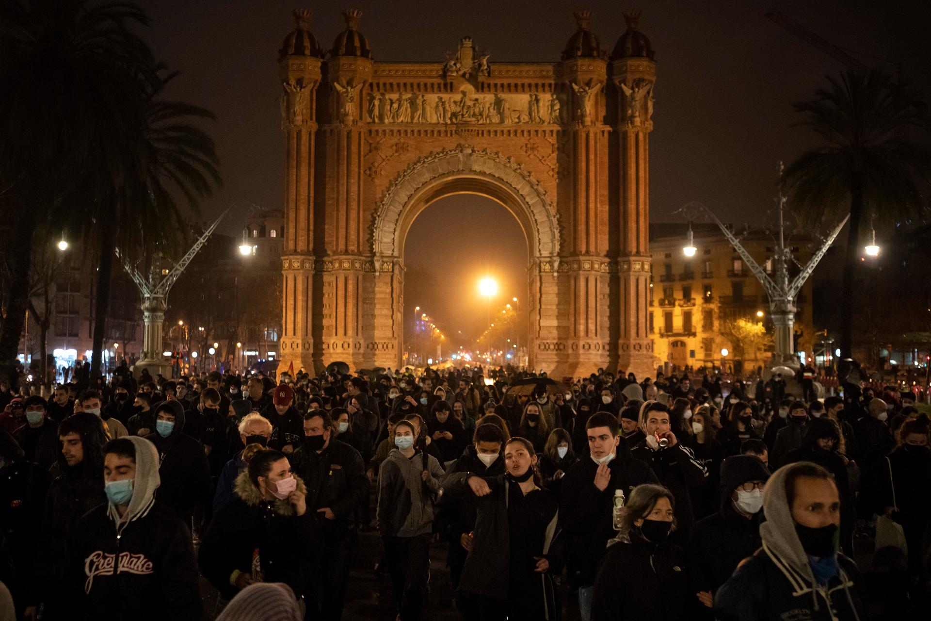 Demonstrators march near the Arch of Triumph during a protest condemning the arrest of rap artist Pablo Hasél in Barcelona, Feb. 22, 2021.