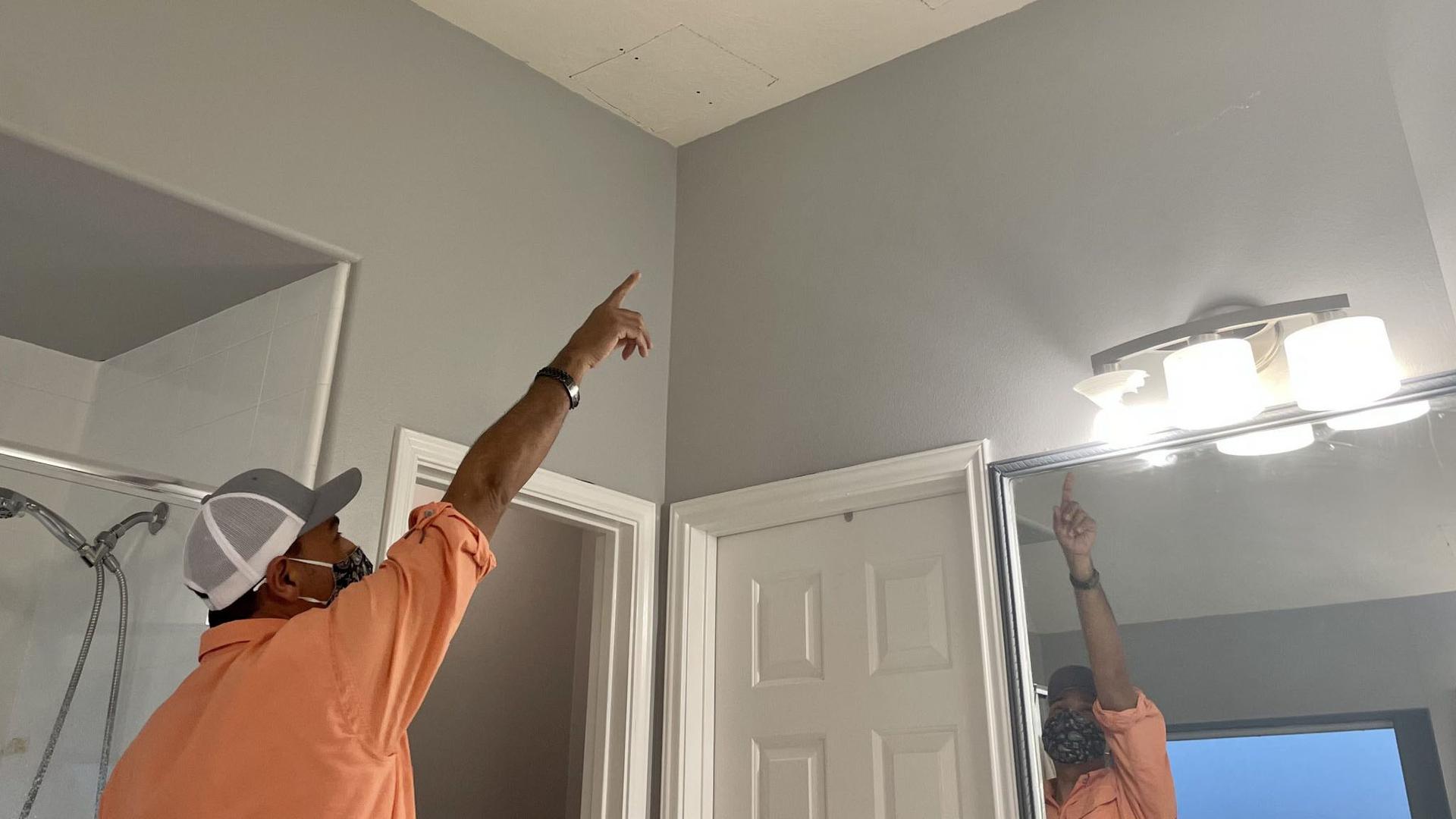 Houston plumber Eduardo Dolande said he had to cut holes in his bathroom ceiling to reach broken pipes during the Texas freeze.