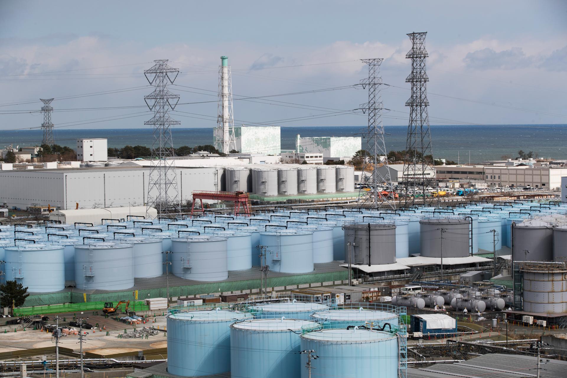 Nuclear reactors of No. 5, center left, and 6 look over tanks storing water that was treated but still radioactive, at the Fukushima Daiichi nuclear power plant