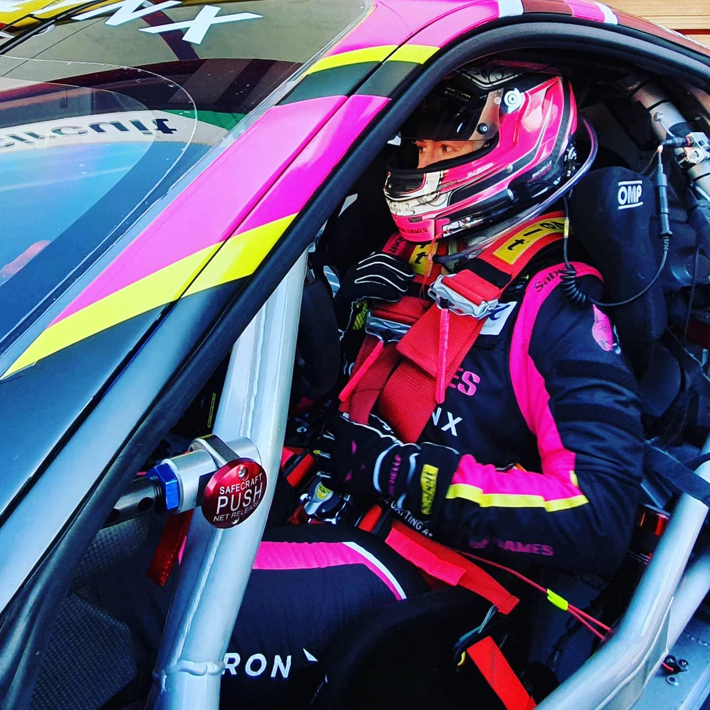 Michelle Gatting sits behind the wheel of her race car.