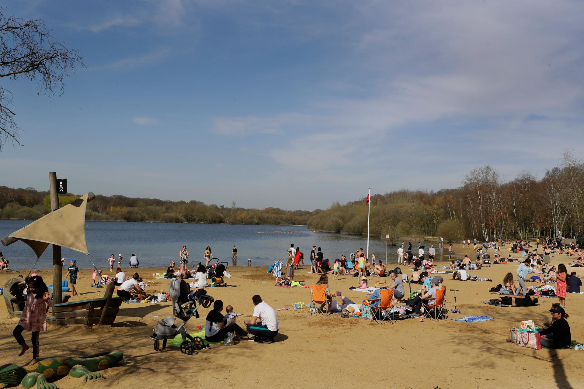 People enjoy the warm weather at Ruislip Lido in London, March 30, 2021. Temperatures in parts of the UK are expected to be significantly warmer this week as families and friends are reunited and outdoor sporting activities are allowed to resume in Englan