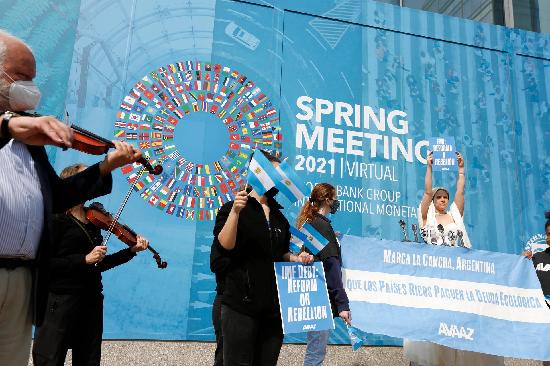 At the entrance of the International Monetary Fund (IMF) Headquarters, an Avaaz.org activist dressed as Eva Peron — also known as Evita — sings "Don't feed the greed Kristalina," an adaptation of "Don't cry for me Argentina" from the hit musical "Evita,"