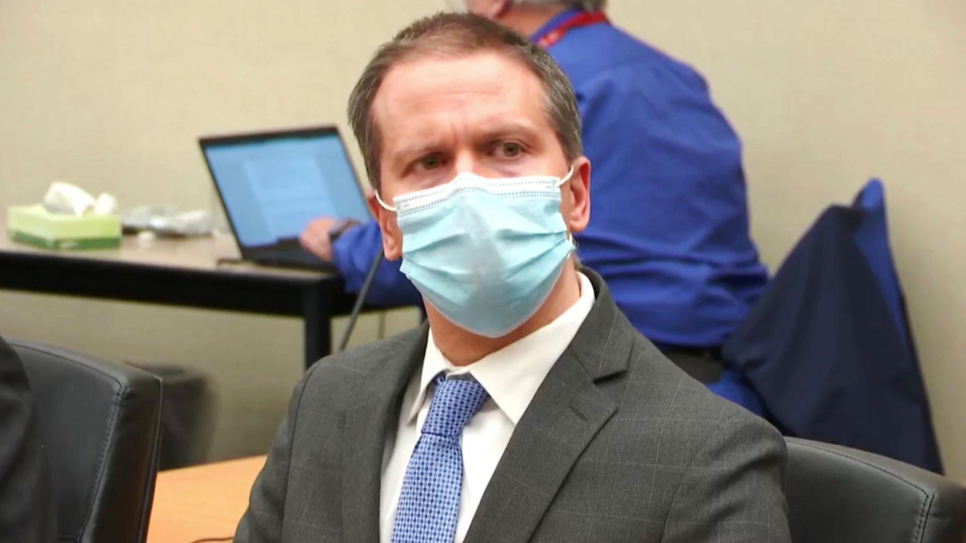 In this image from video, defendant, former Minneapolis police Officer Derek Chauvin is shown wearing a face mask, gray suit and blue tie.