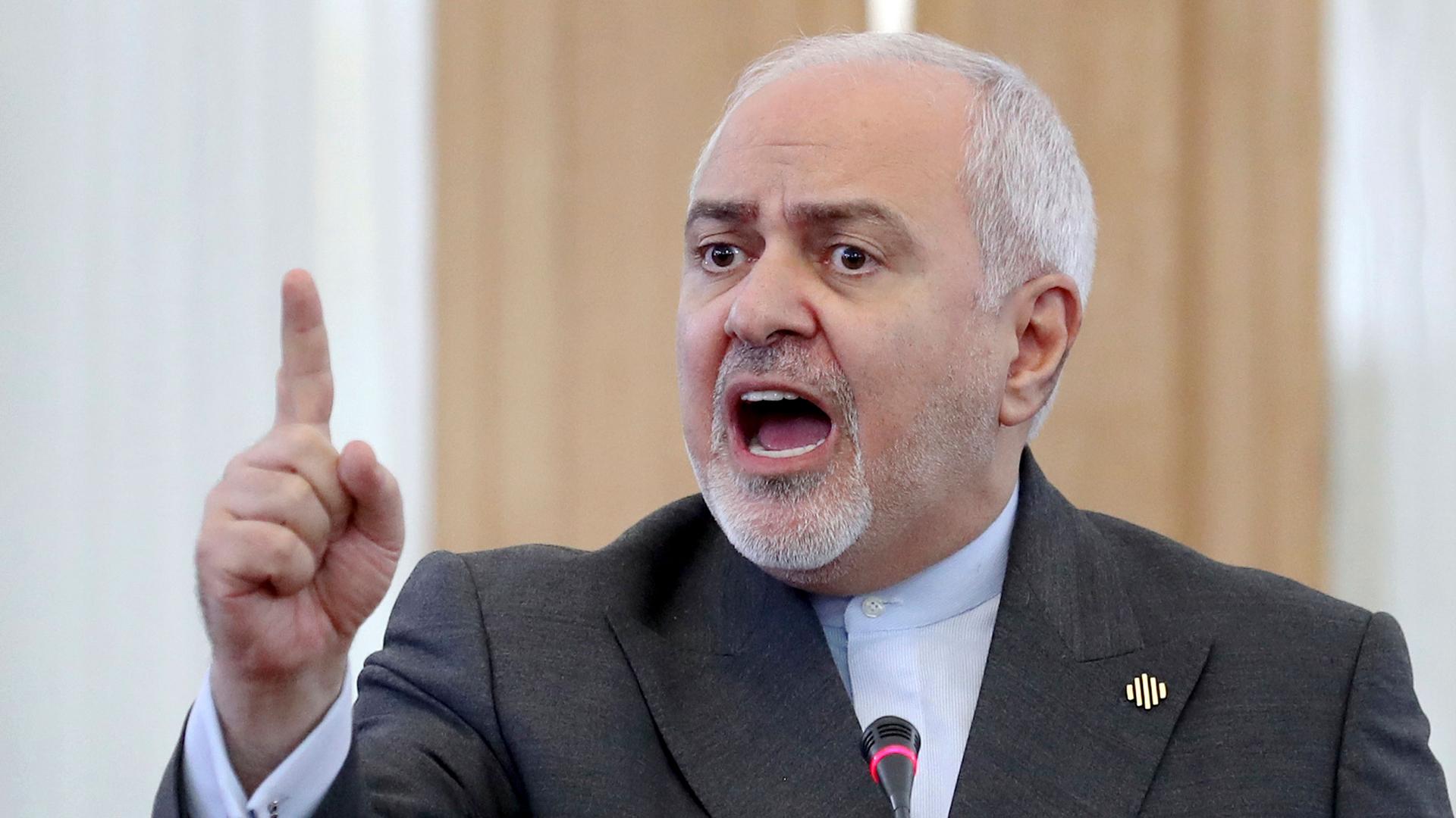 Iranian Foreign Minister Mohammad Javad Zarif is shown speaking and with his right hand rised and point his finger in the air.