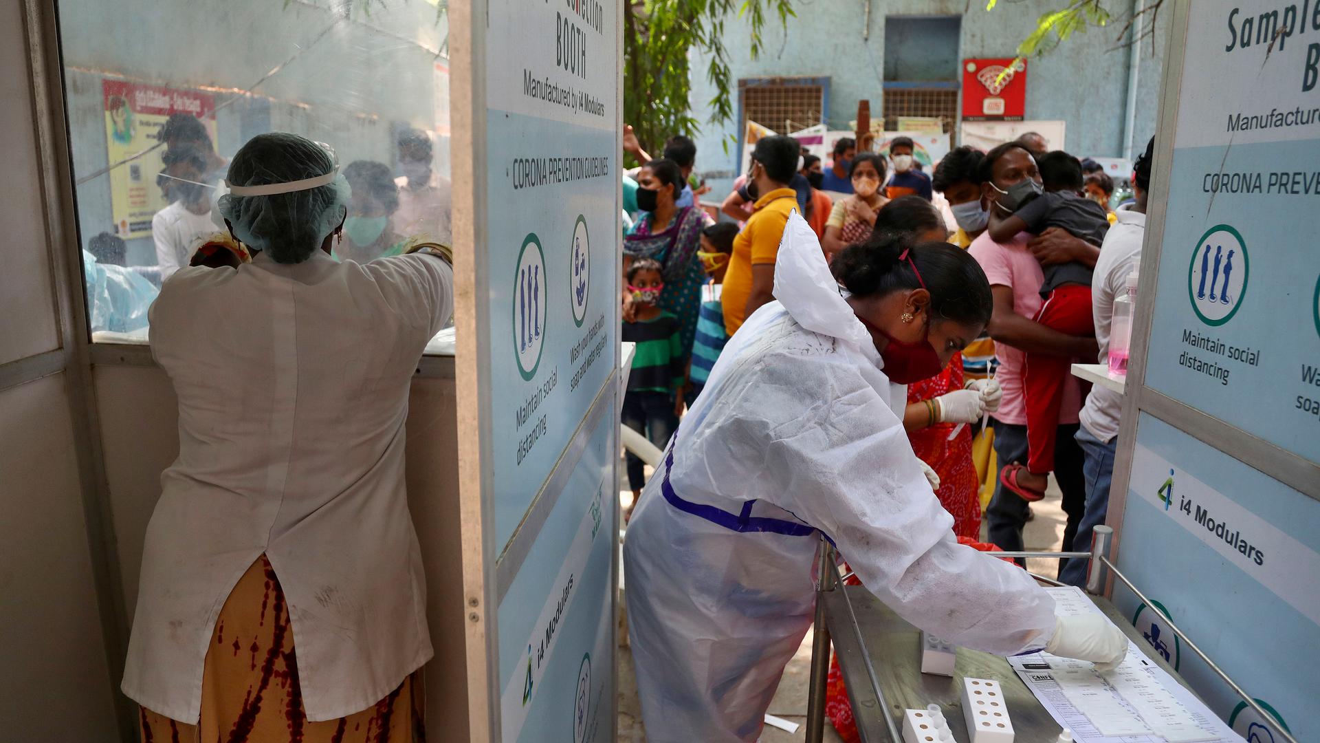 People wait their turn to get tested for COVID-19 in Hyderabad, India, April 25, 2021.