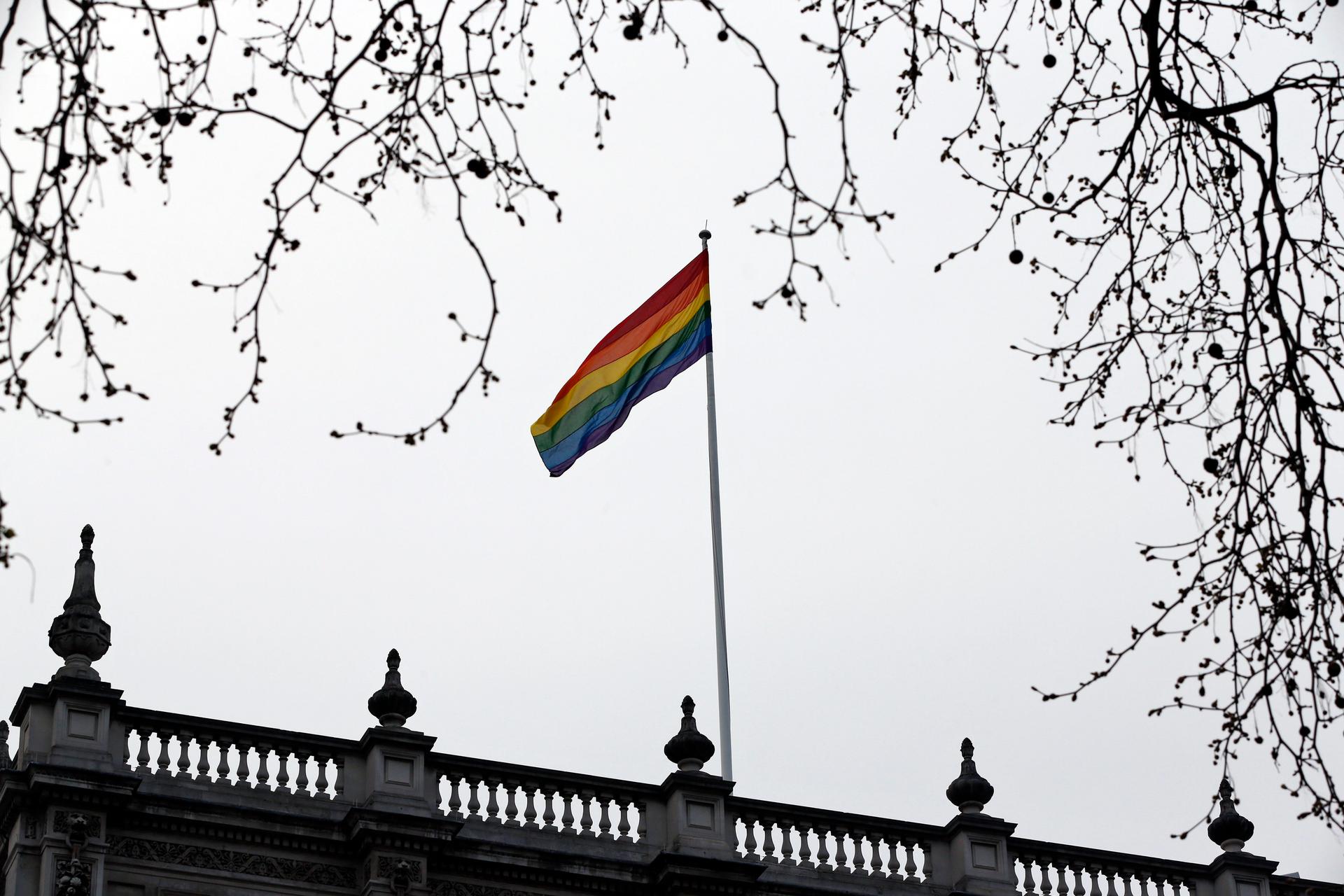 The rainbow flag, a symbol of the lesbian, gay, bisexual, and transgender community, flies over the British Government Cabinet Offices building, in central London, Friday, March 28, 2014.