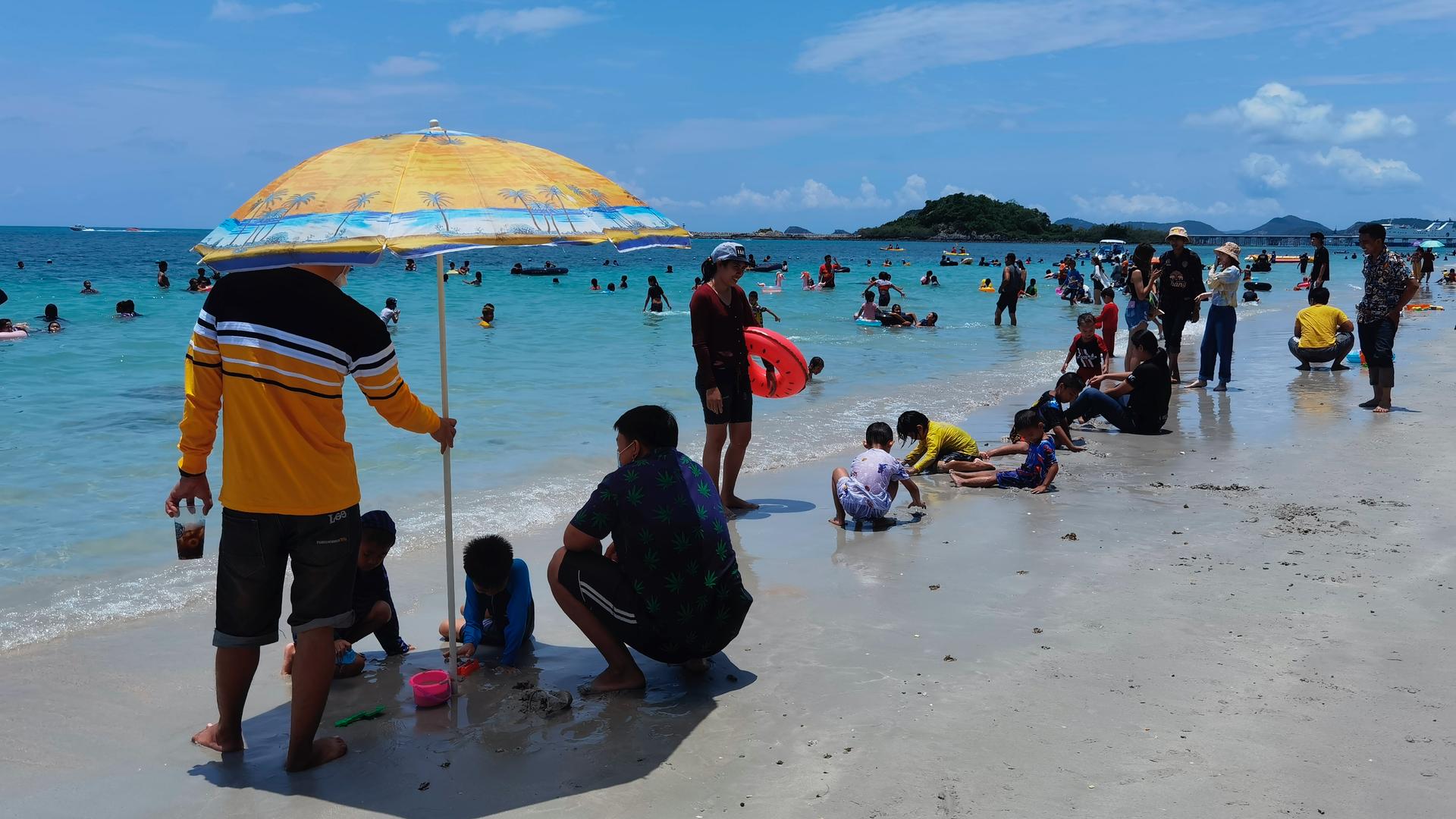 People spend the first day of the Songkran New Year holidays at Nang Rong beach in Chonburi, Thailand, April 13, 2021. 
