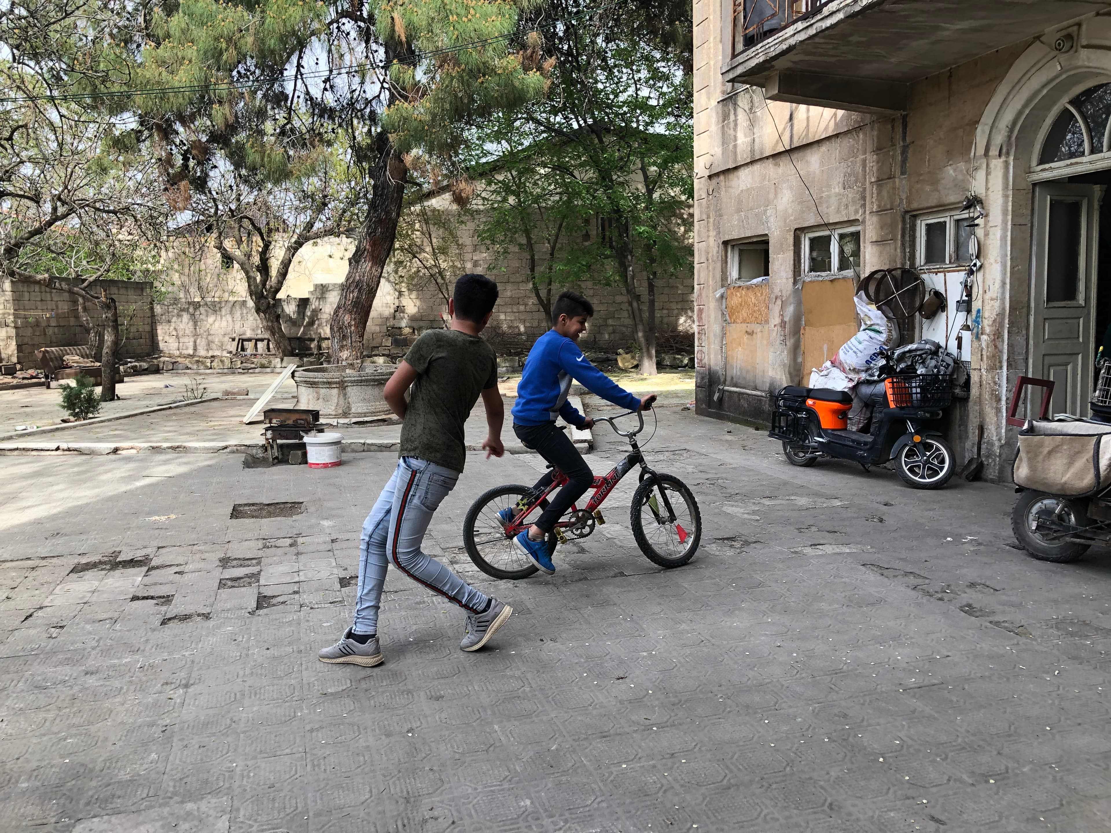 Salim Abdul Ghani has been checking in with Sharifa Riza and her four young sons since the start of the pandemic. They live in an abandoned house tucked away at the end of a narrow alleyway. Riza’s sons went to the Rainbow Center.