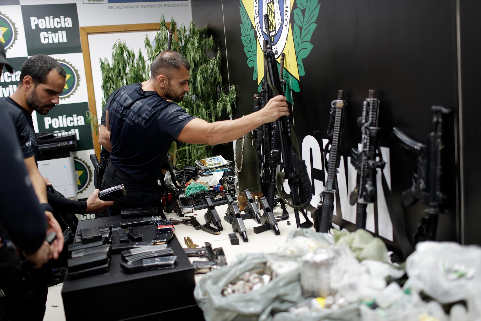 Weapons and drugs seized during a police raid are displayed for the press at city police headquarters in Rio de Janeiro, Brazil, May 6, 2021. 