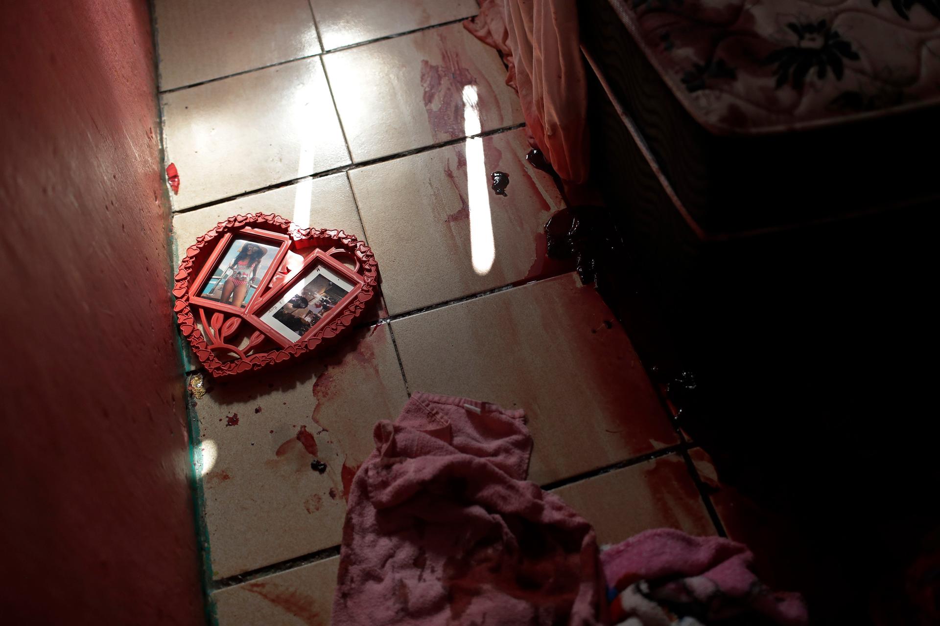 Blood covers the floor and a picture frame in a shape of a heart, inside a home during a police raid targeting drug traffickers in the Jacarezinho favela of Rio de Janeiro, Brazil, May 6, 2021.