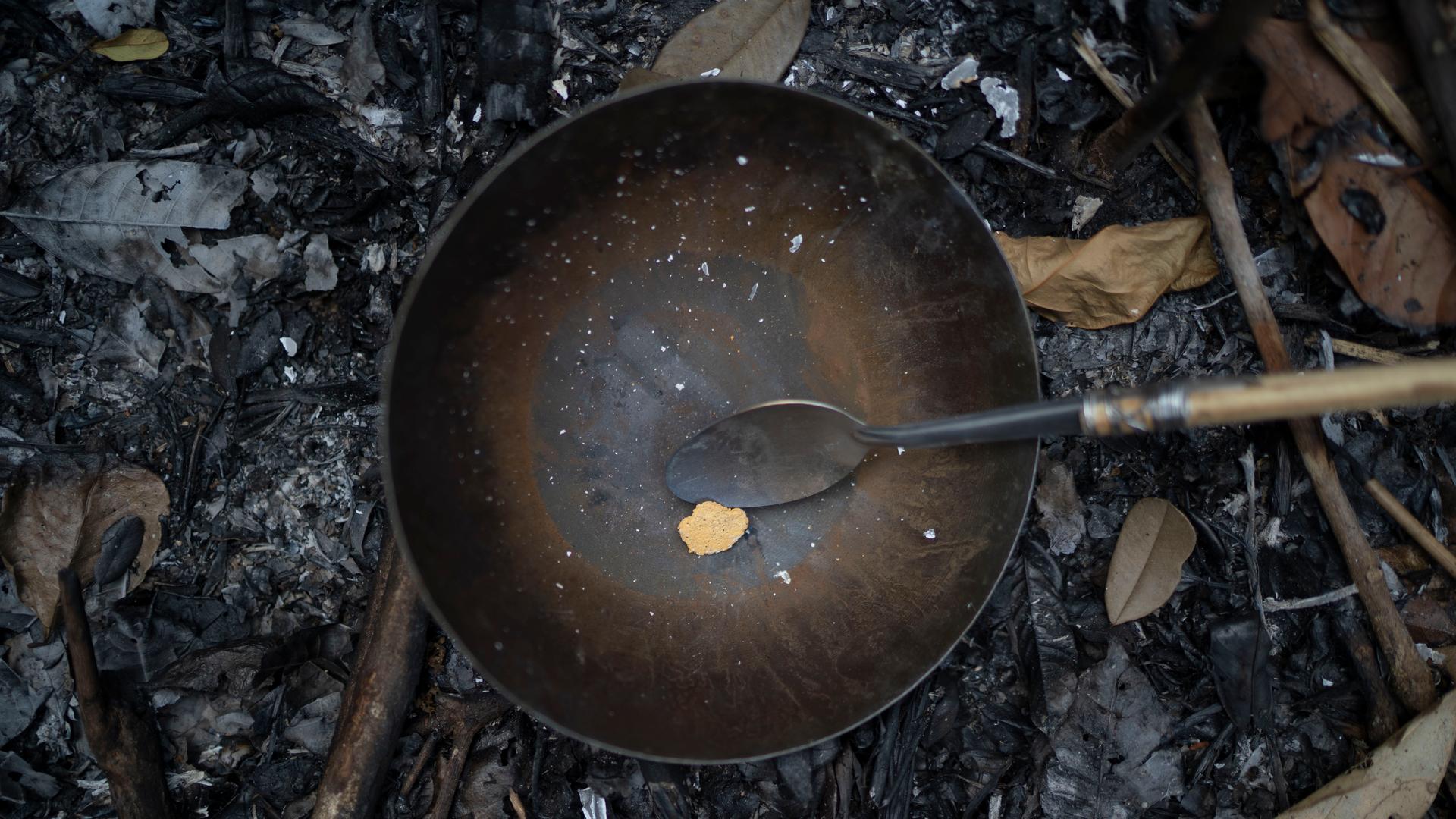 Gold sits in a pan moments after being torched to eliminate any mercury left, at an illegal mine the Amazon jungle, in the Itaituba area of Para state, Brazil, Friday, Aug. 21, 2020. 
