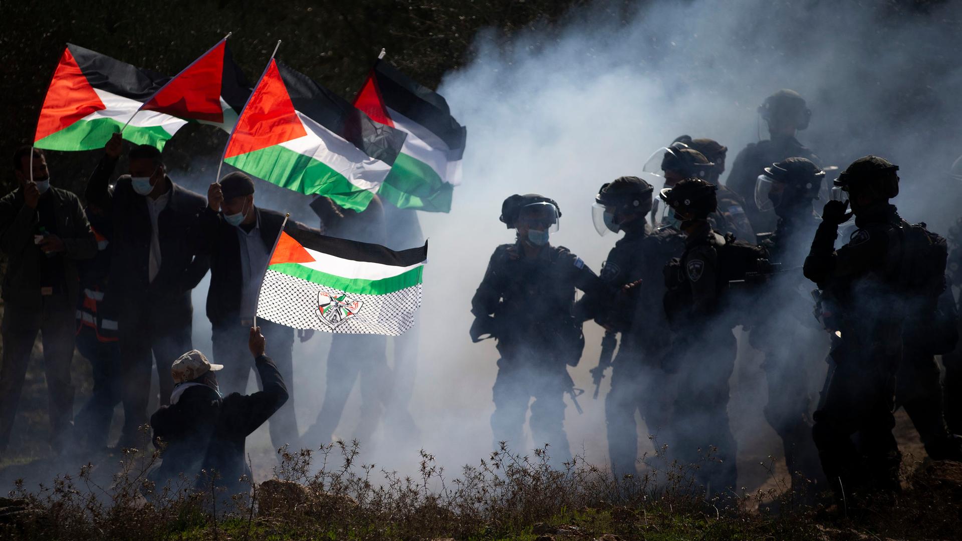 Israeli border police officers and Palestinians clash during a protest against the expansion of Israeli Jewish settlements near the West Bank town of Salfit. 