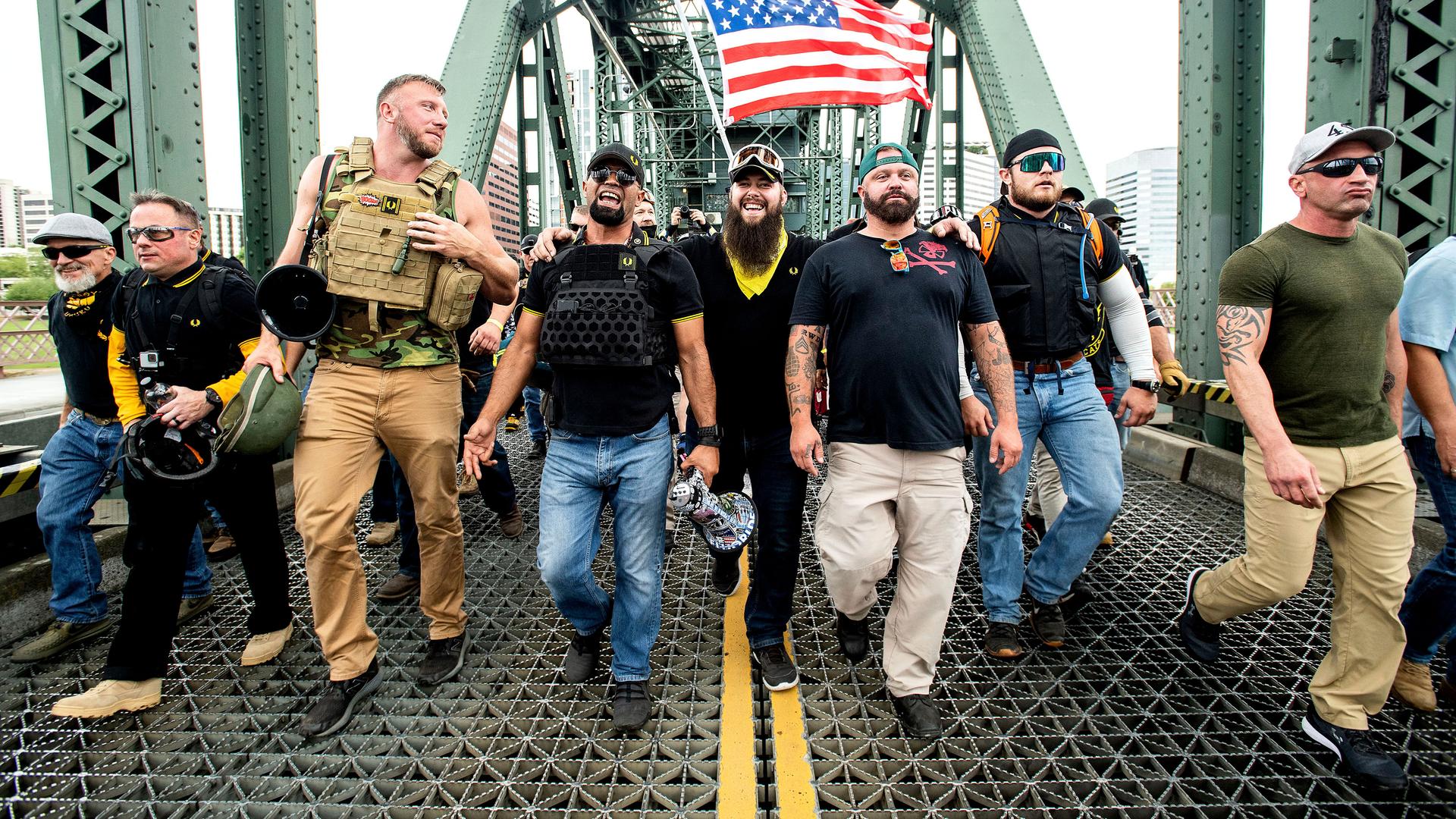 Members of the Proud Boys and other right-wing demonstrators march across the Hawthorne Bridge during an 