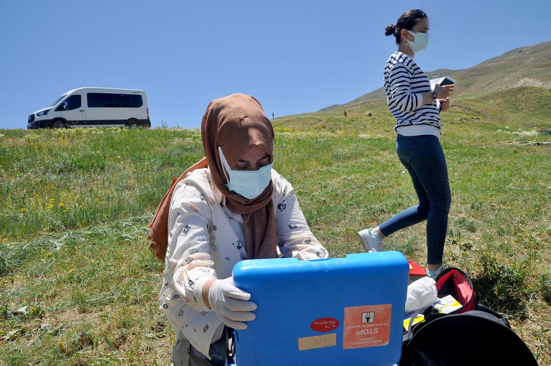 A health worker unloads equipment to vaccinate sheepherders in Ömerova, a village in Turkey’s eastern Kurdish region.