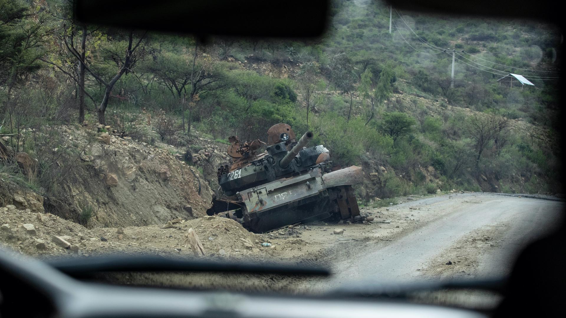 A destroyed tank sits by the side of a road leading to Abi Adi, in the Tigray region of northern Ethiopia, May 11, 2021. 