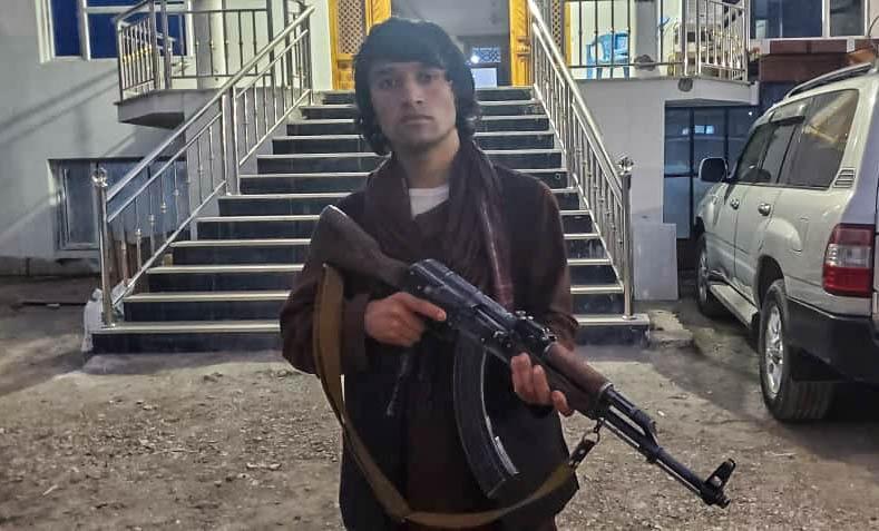 Twenty-year-old Safar Mohammad holds his AK-47 at a popular mobilization headquarter in Baghlan province in northern Afghanistan.