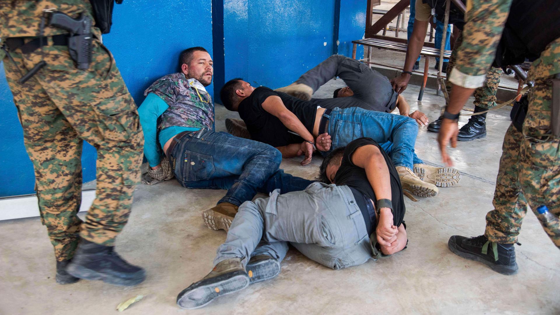 Suspects in the assassination of Haiti's President Jovenel Moïse are tossed on the floor after being detained.