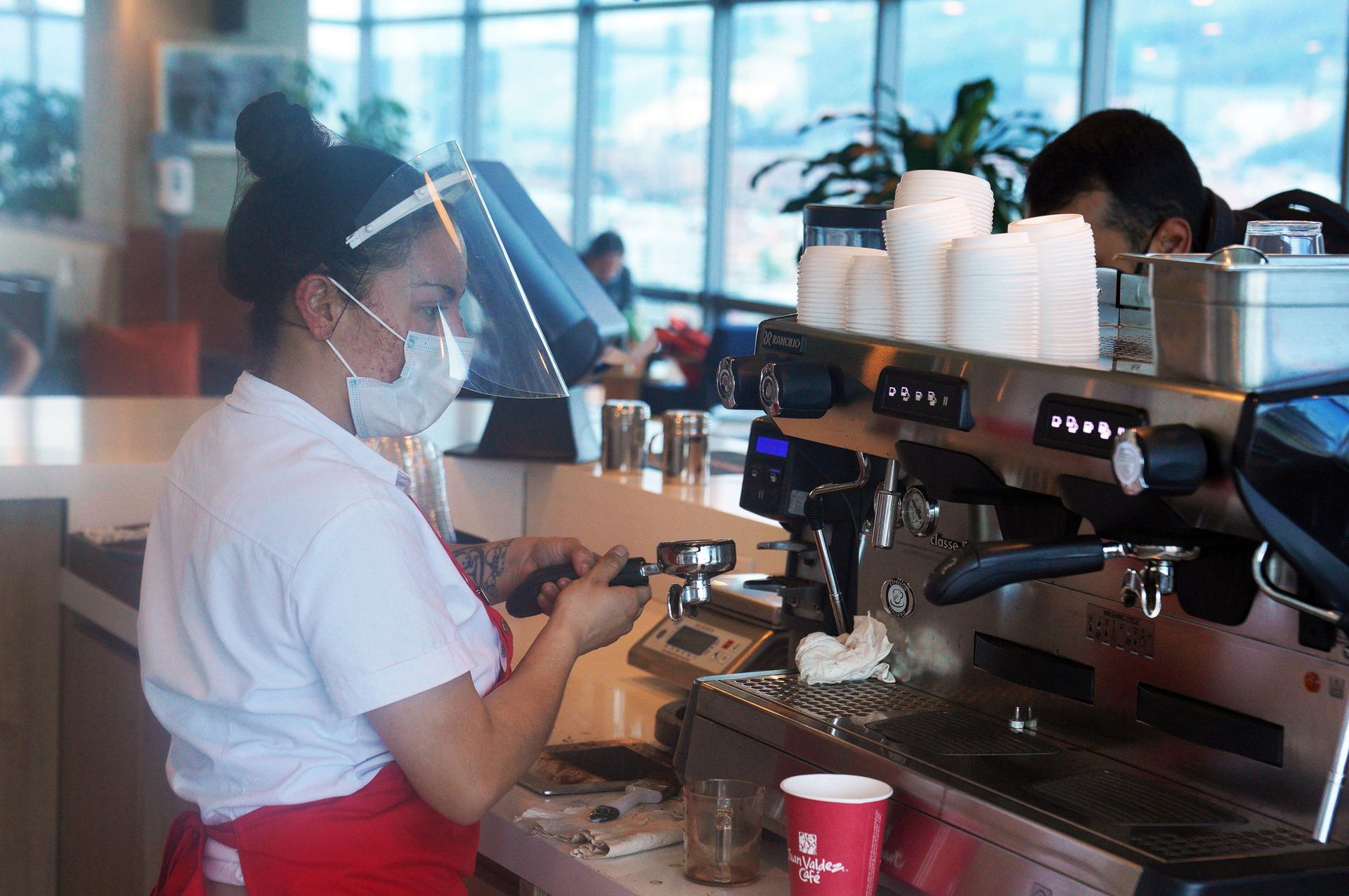 Sandra Salazar wears protective gear as a barista behind the counter.