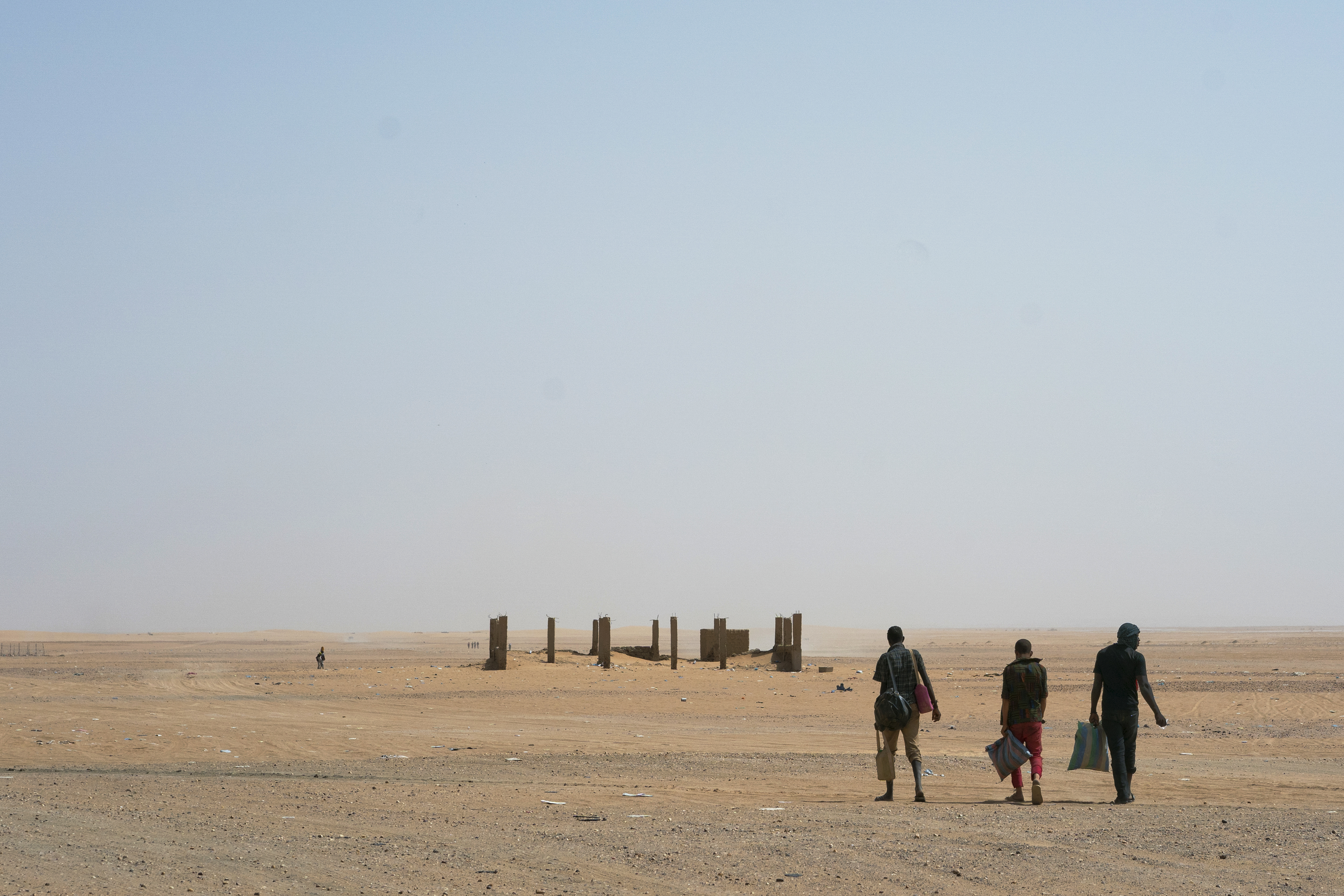 Three men head north toward Algeria after crossing the Assamaka border post in northern Niger, June 3, 2018. 