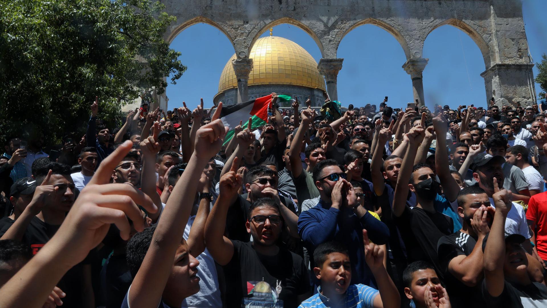 Palestinians chant slogans during a protest in front of the Dome of the Rock Mosque at the Al Aqsa Mosque compound in Jerusalem's Old City, Friday, June 18, 2021. 