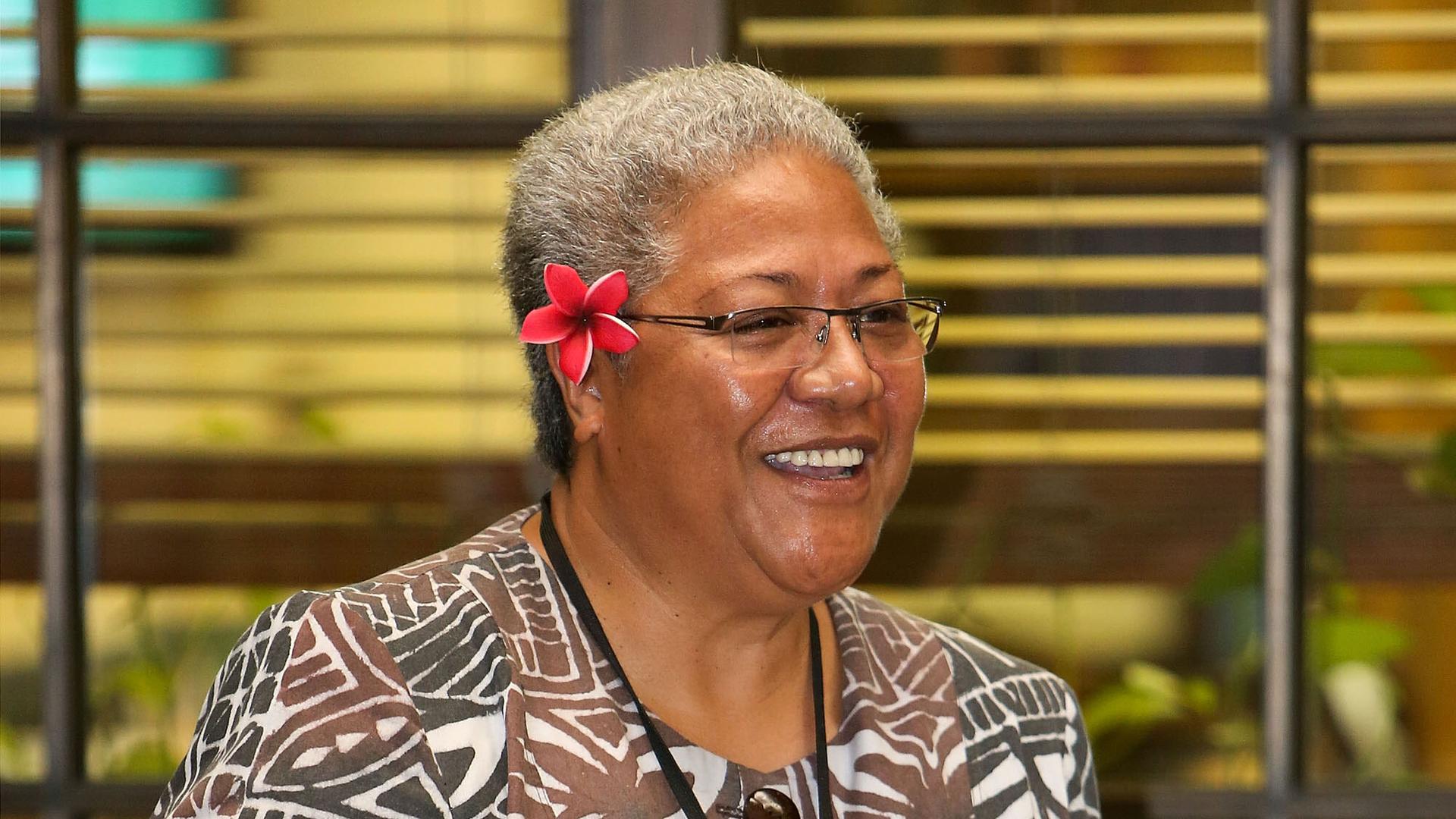 Samoa MP Fiamē Naomi Mata'afa smiles with a red flower in her hair
