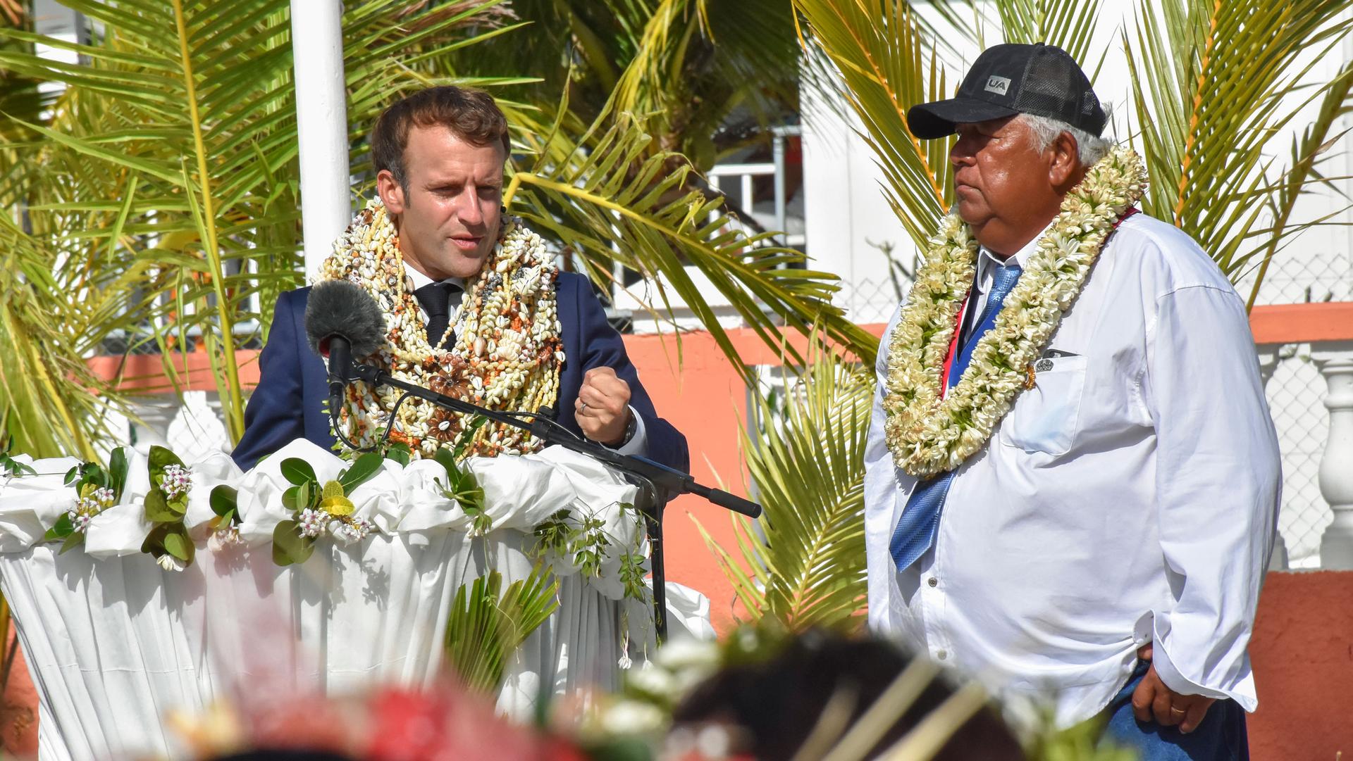 France's President Emmanuel Macron wears a flowers leis and seashell necklaces gestures as he speaks up on his arrival as the mayor Manihi John Drollet stands next to him at the Manihi Atoll, 312 miles northeast of Tahiti, French Polynesia. 