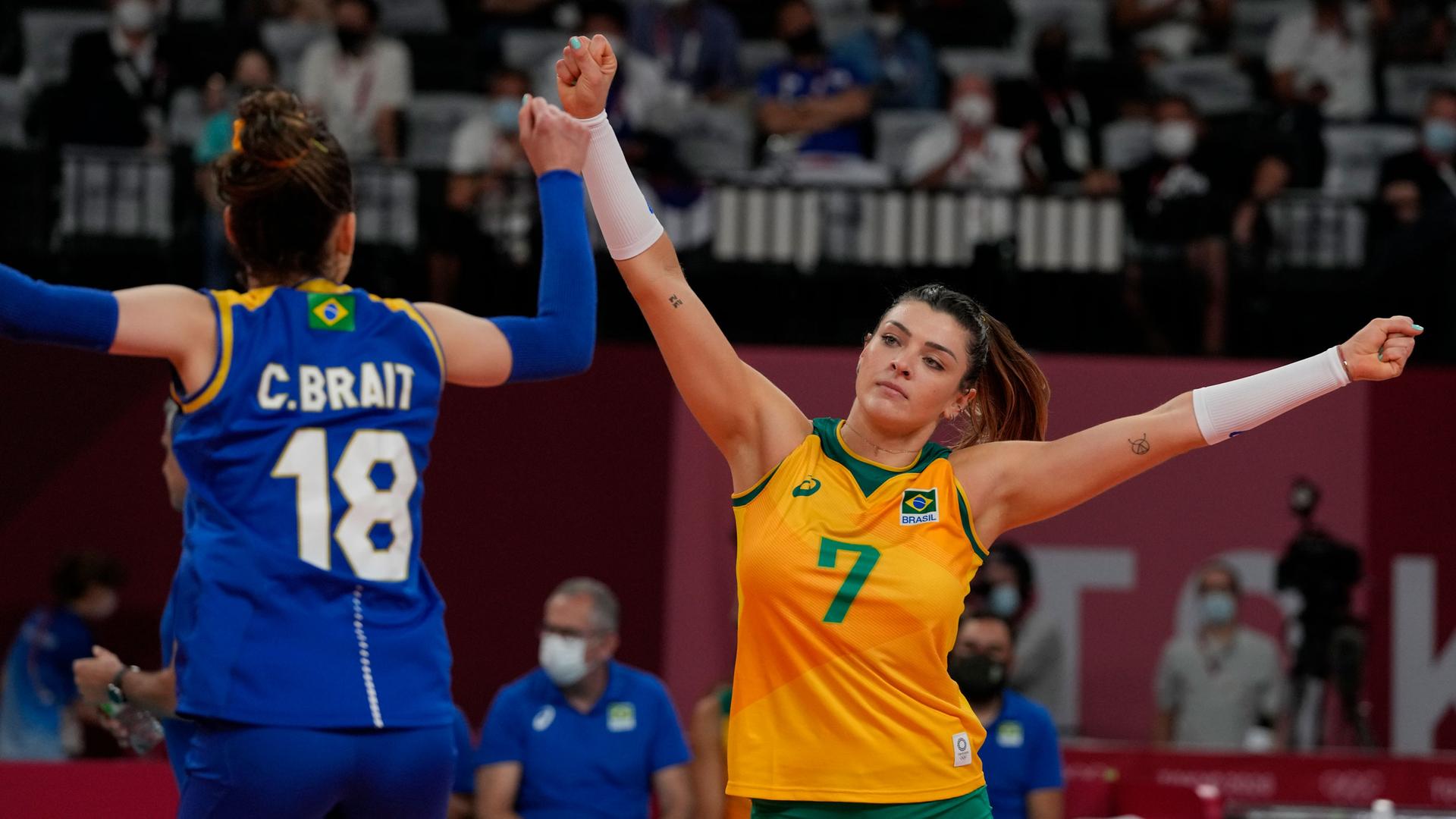 Brazil's libero Camila Brait and teammate Rosamaria Montibeller fist bump during a women's volleyball semifinal match against South Korea, at the 2020 Summer Olympics, Friday, Aug. 6, 2021, in Tokyo, Japan. 