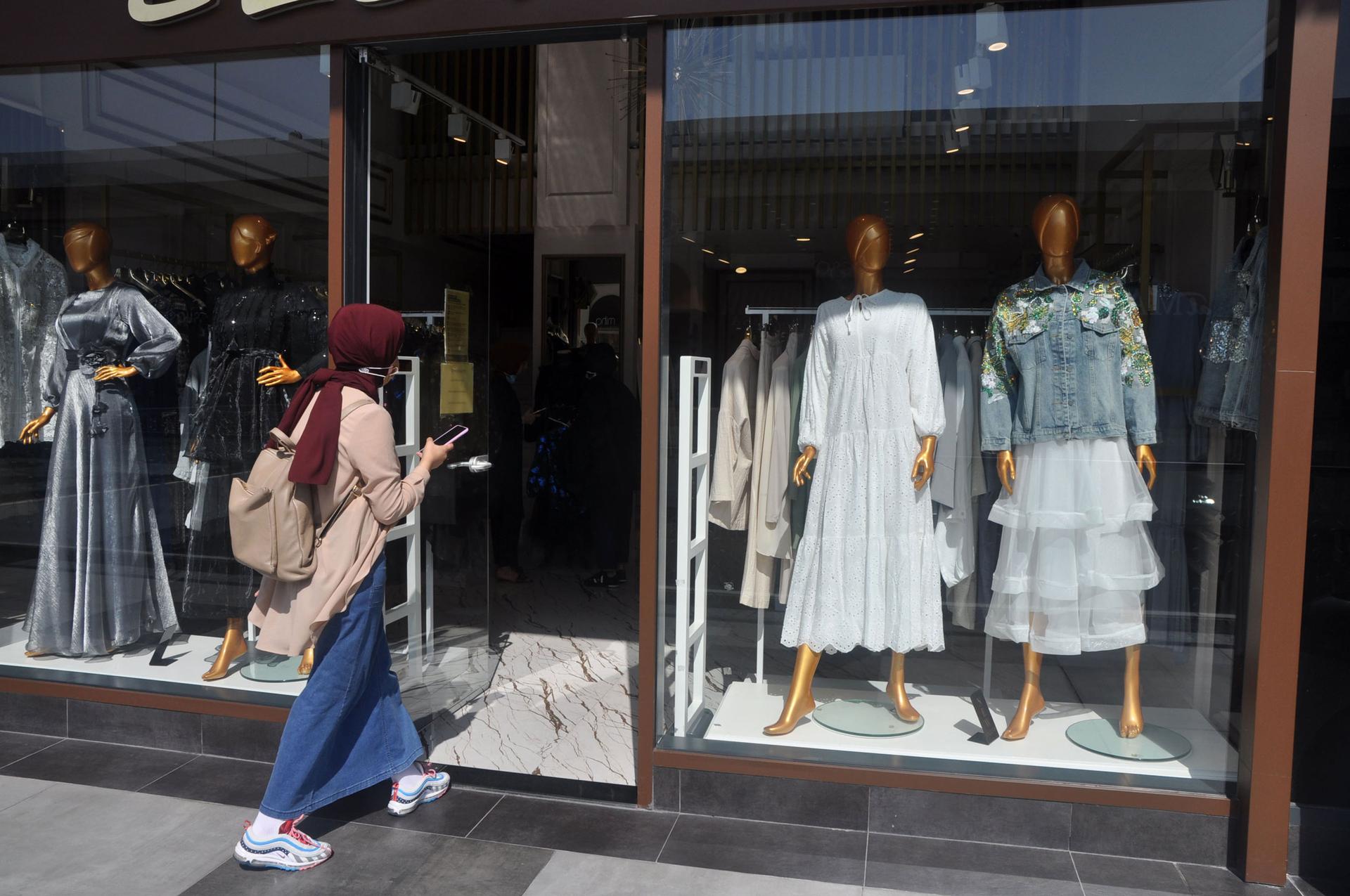 A woman enters a modest fashion clothing store in Istanbul.
