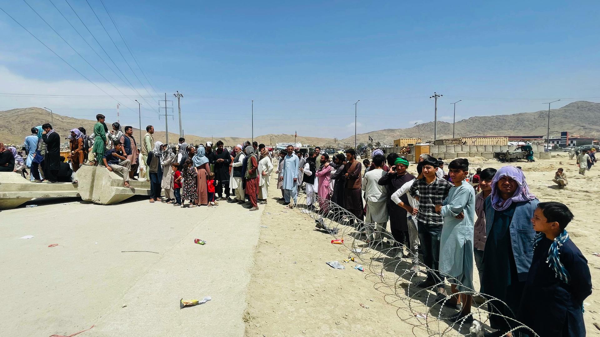 Hundreds of people gather outside the international airport in Kabul, Afghanistan, Aug. 17, 2021. 