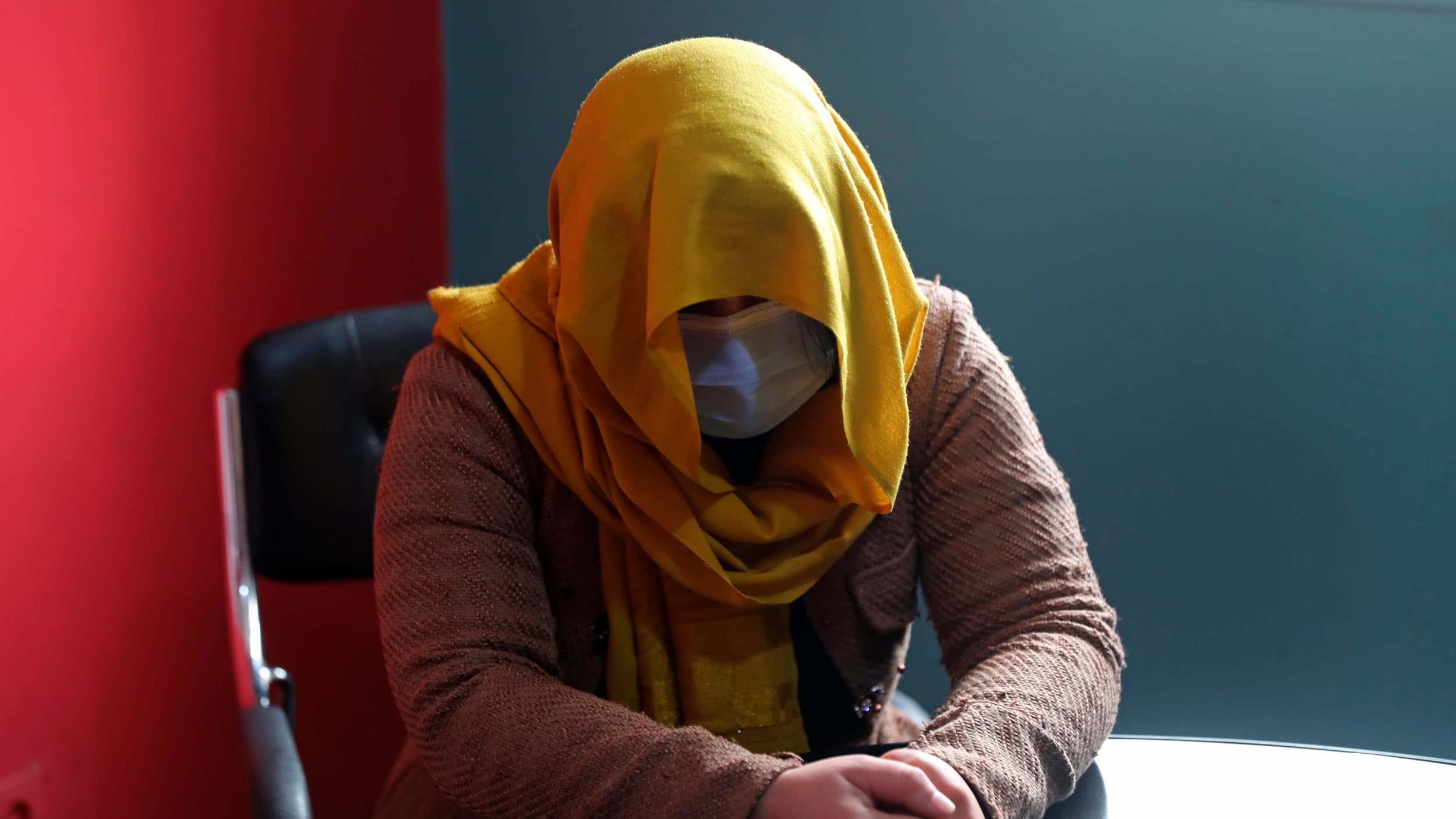 A female TV presenter from southern Afghanistan hides her identity for security concerns as she gives an interview to The Associated Press in Kabul, Afghanistan, Wednesday, Feb. 3, 2021.