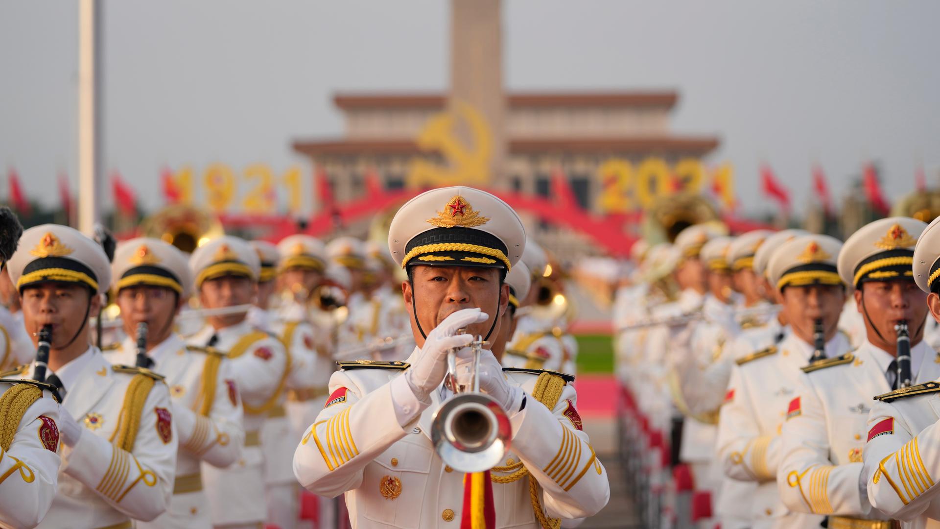A military band rehearses for a ceremony to mark the 100th anniversary of the founding of the ruling Chinese Communist Party at Tiananmen Gate in Beijing, July 1, 2021. Chinese fighter jets, anti-submarine aircraft and combat ships conducted assault drill