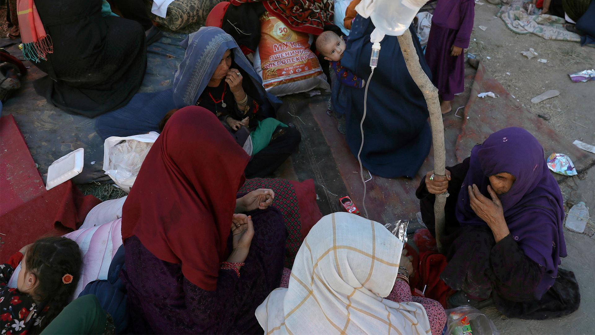 Internally displaced Afghan women from northern provinces, who fled their home due to fighting between the Taliban and Afghan security personnel, receive medical care in a public park in Kabul, Afghanistan