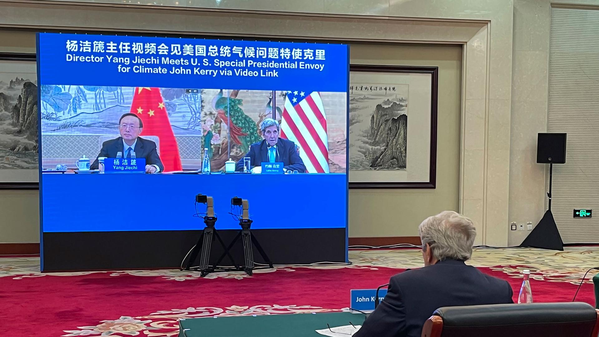 In this Sept. 2, 2021, file photo provided by the US Department of State, US Special Presidential Envoy for Climate John Kerry attends a meeting with Yang Jiechi, director of China's Office of the Central Commission for Foreign Affairs