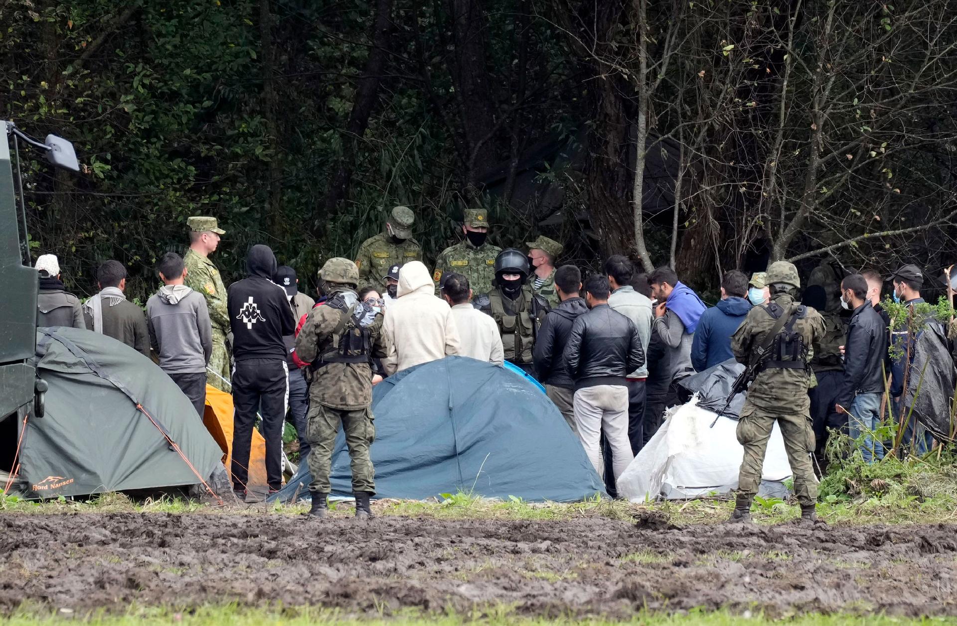Polish security forces surround migrants stuck along with border with Belarus in Usnarz Gorny, Poland, on Wednesday, Sept. 1, 2021. 