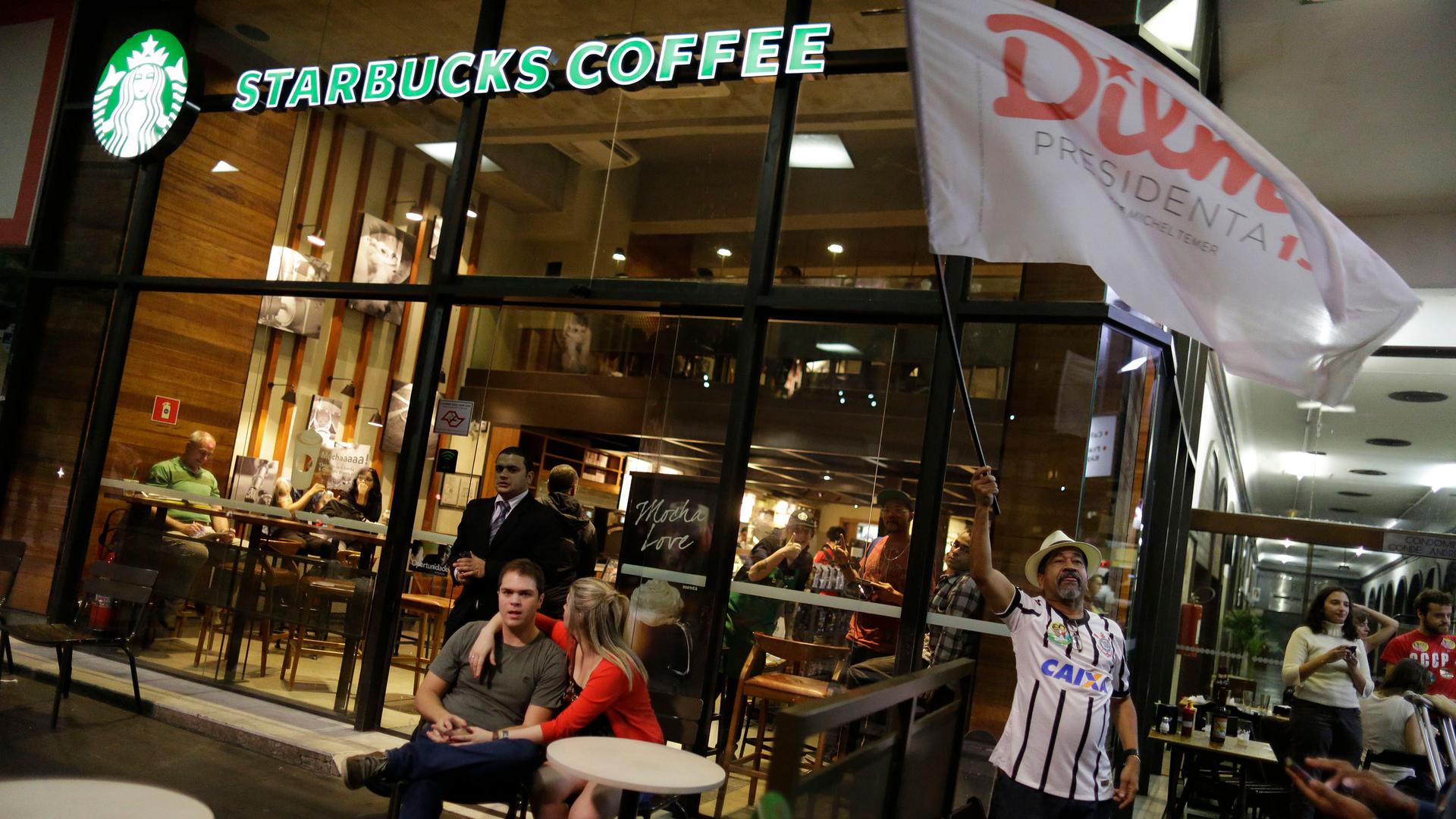Brazilians gather in front of a Starbucks coffee shop in Sao Paulo, Brazil, Sunday, Oct. 26, 2014. Recent extreme weather events have taken a toll on Brazil's coffee crops, straining the global coffee supply chain. 