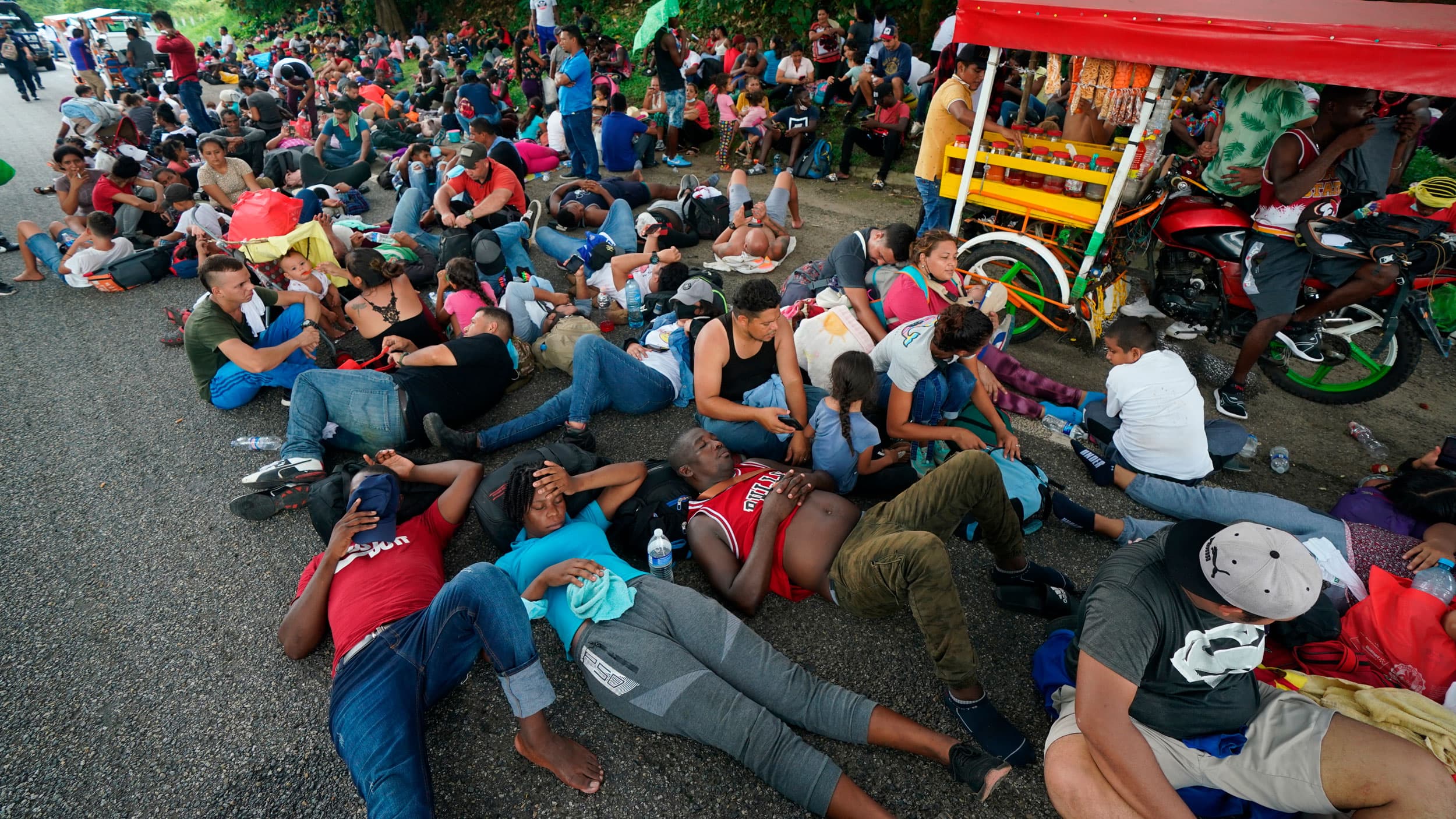 Migrants who are part of a large group heading north stop to rest along the Huehuetan highway, Chiapas state, Mexico, Saturday, Sept. 4, 2021.