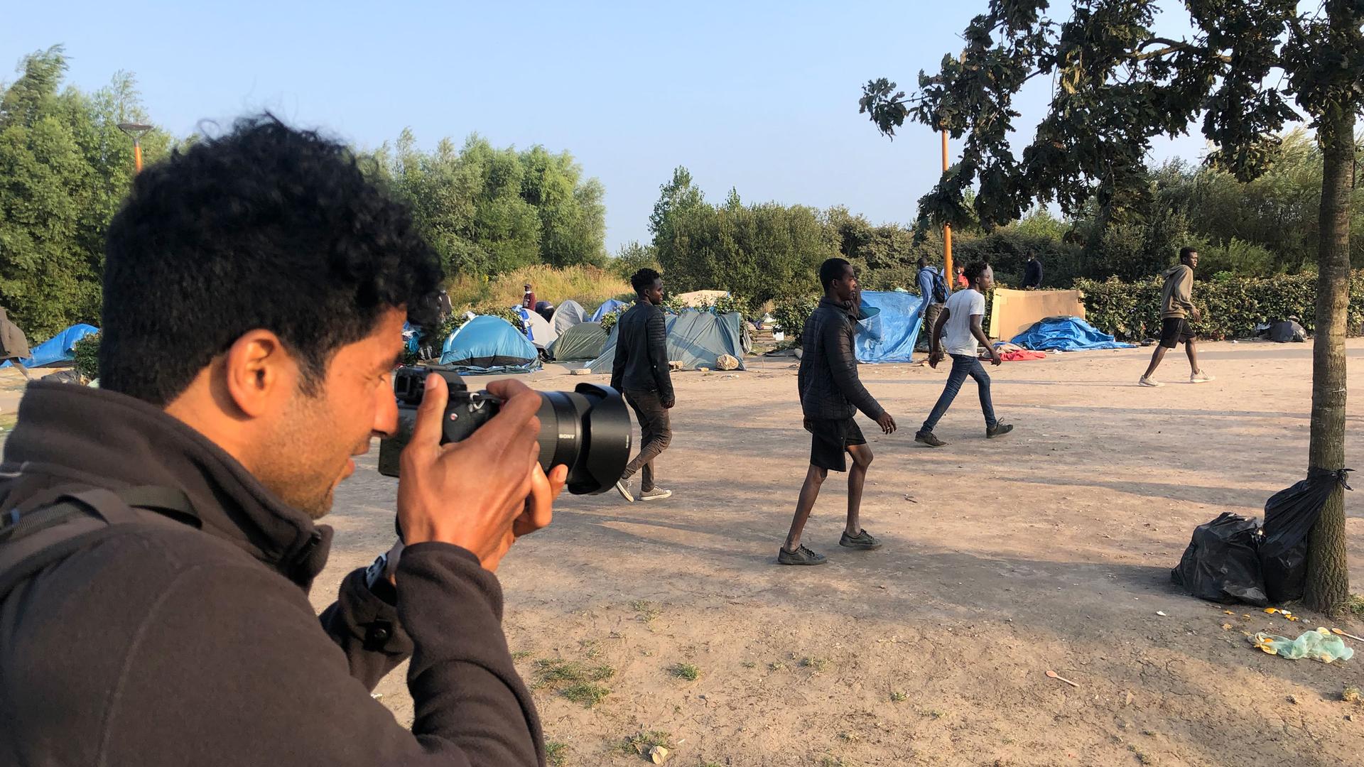 Abdul Saboor, an award-winning Afghan photographer in France, documents a soccer game at a refugee encampment in Calaís, France. 