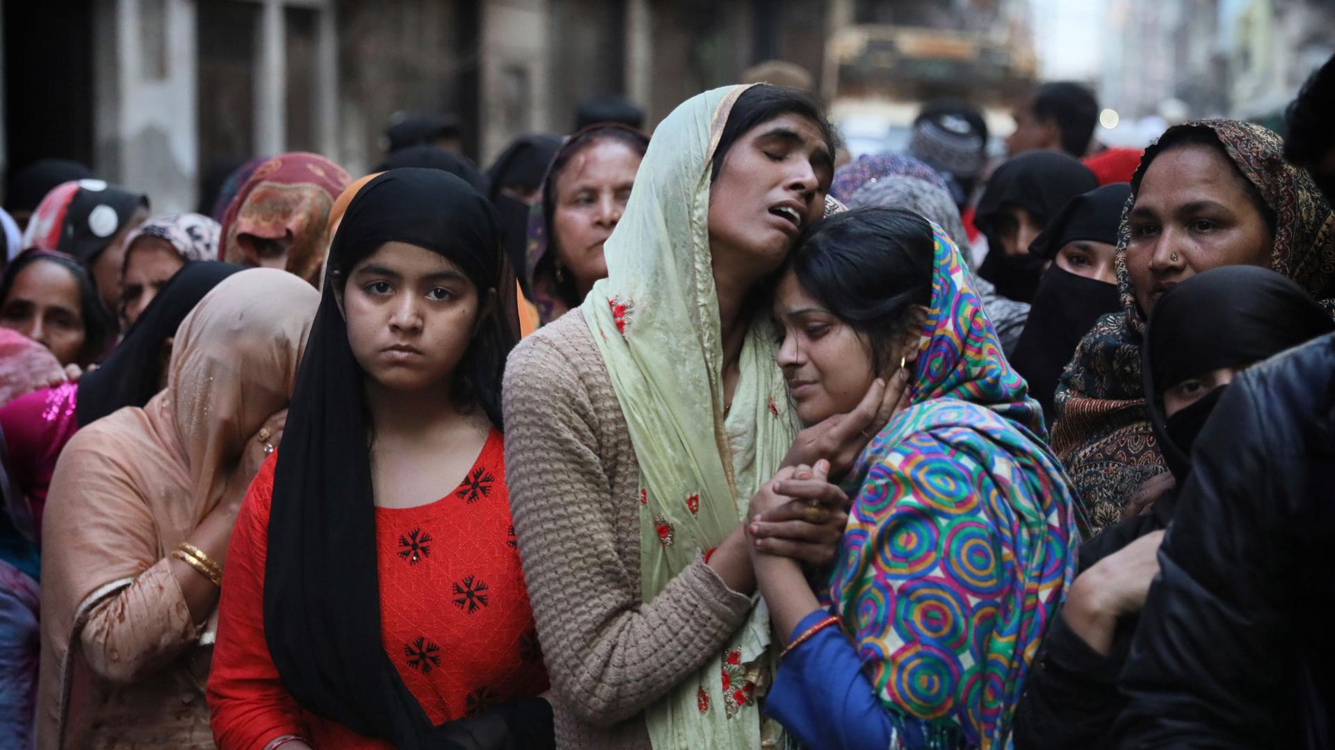 Relatives and neighbors wail near the body of Mohammad Mudasir, 31, who was killed in communal violence in New Delhi, India, Thursday, Feb. 27, 2020. 